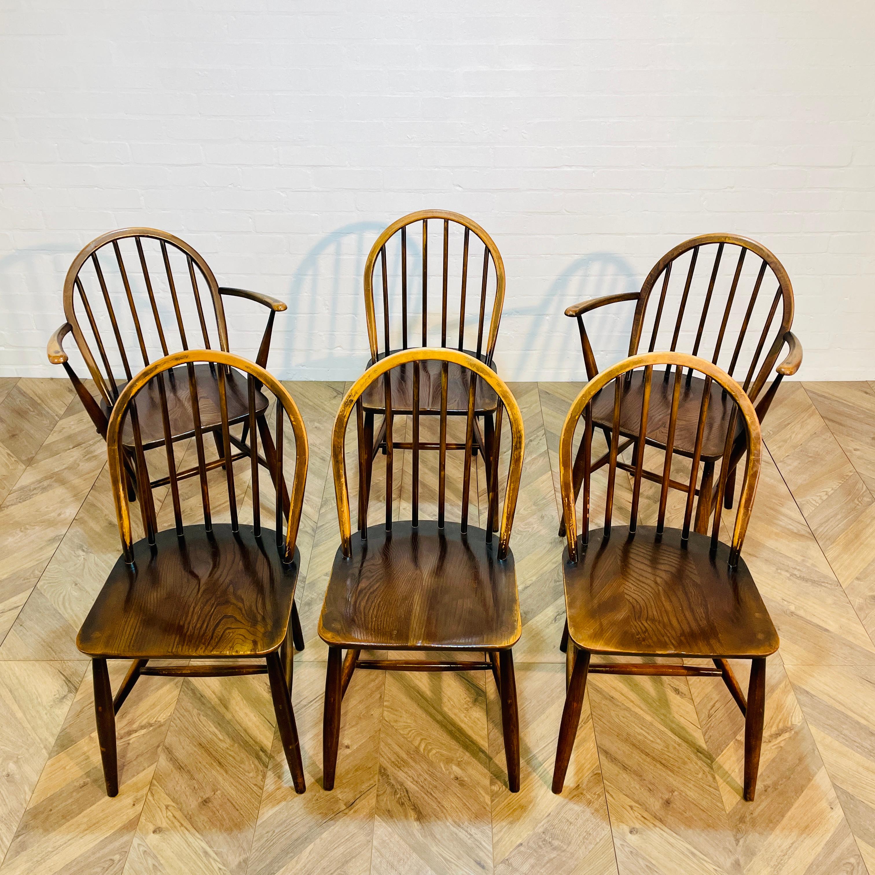 Set of 6, Ercol Windsor Hoop-Back Chairs, 1960s. 4x Standard Chairs, 2x Carver Armchairs.

Designed by Lucian Ercolani, the chairs seamlessly blend contemporary British design and traditional craftsmanship.

The chairs are made from solid beech with