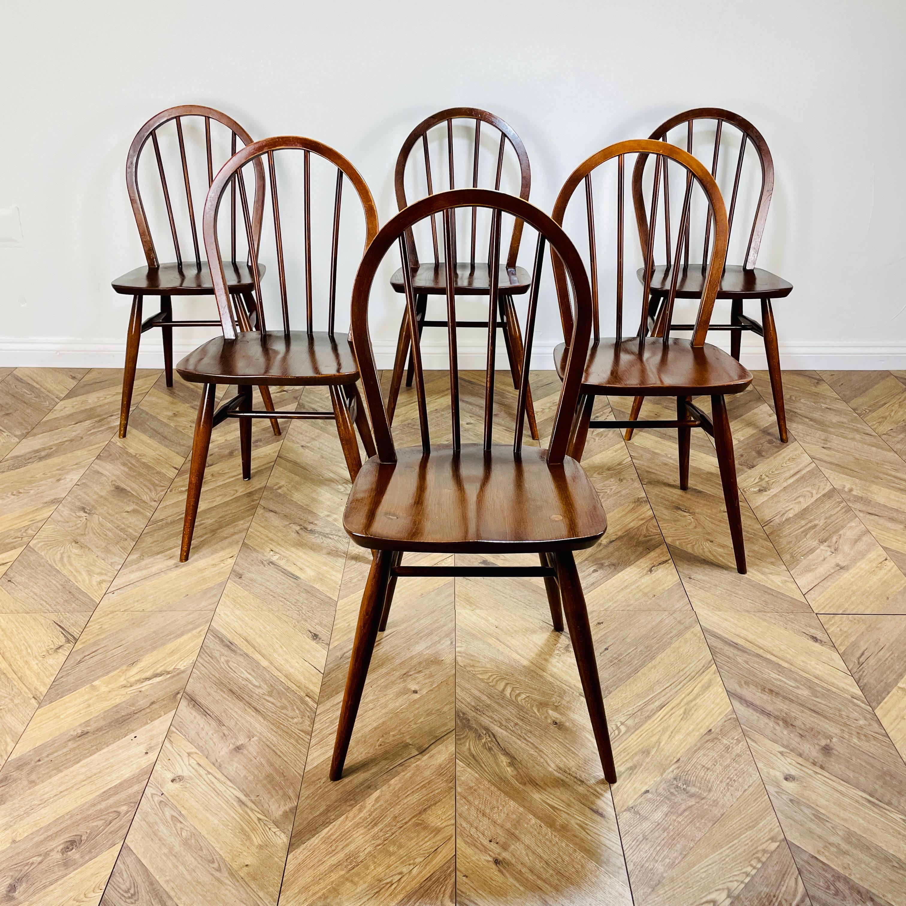 Set of 6, Ercol Windsor Model 400 Hoop-Back Chairs, 1950s.

Designed by Lucian Ercolani, the chairs seamlessly blend contemporary British design and traditional craftsmanship.

The chairs are made from solid beech with elm seats and boast a