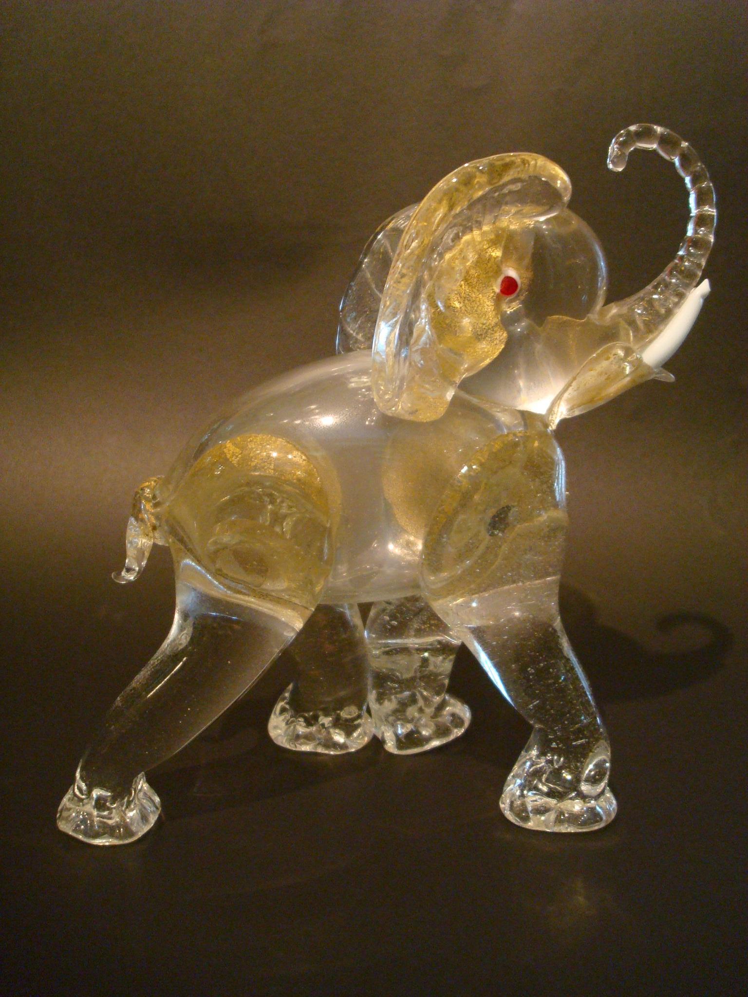 Gorgeous early gold Murano glass elephant figure / sculpture, circa 1930s-1940s. Clear glass with gold foil application, lattimo tusks, red-centred white eyes. Designed by Ercole Barovier
Perfect condition.
