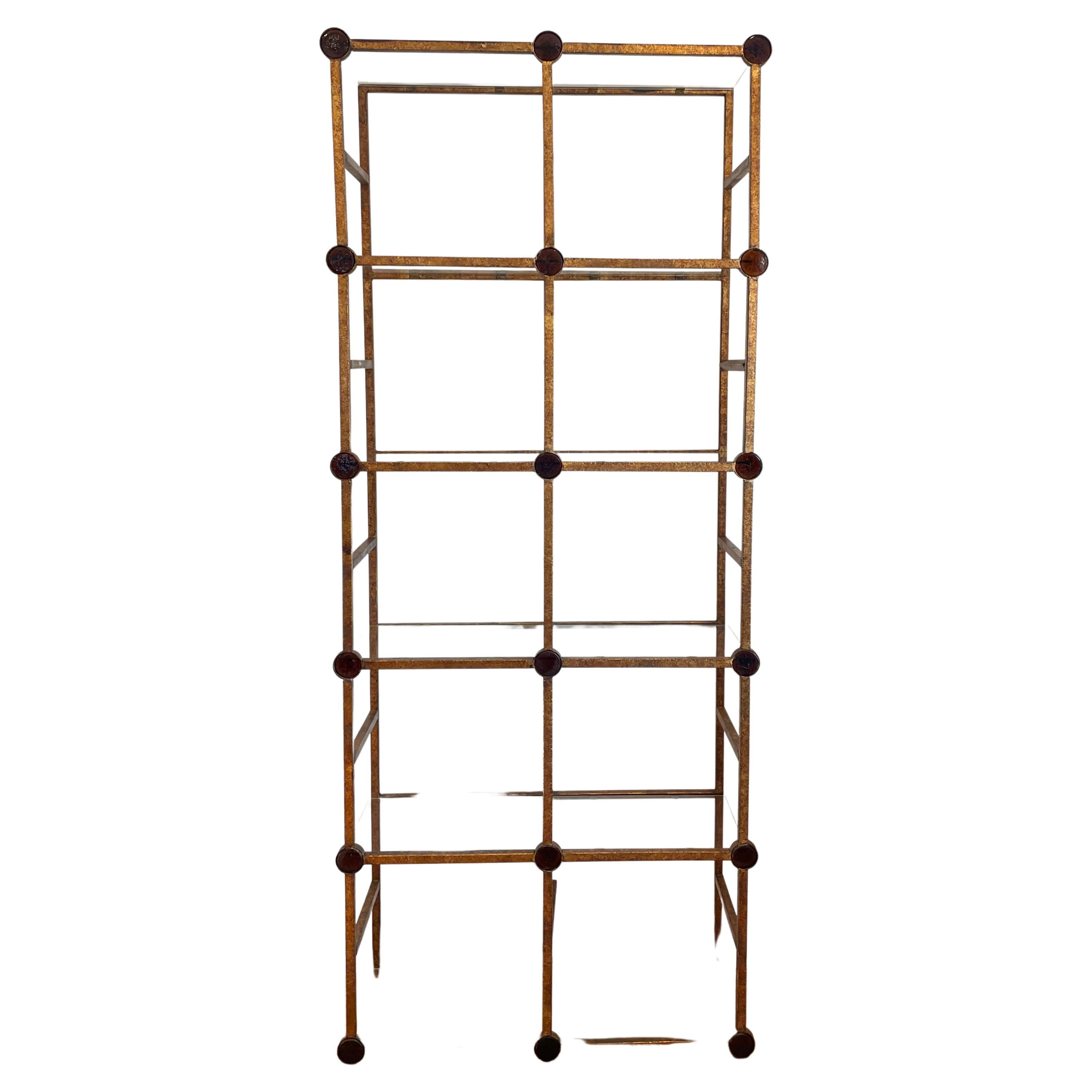 Beautiful unique mid century Etagere. Hammered and gilt metal frame with amber colored glass discs, with six glass shelves, flush base.