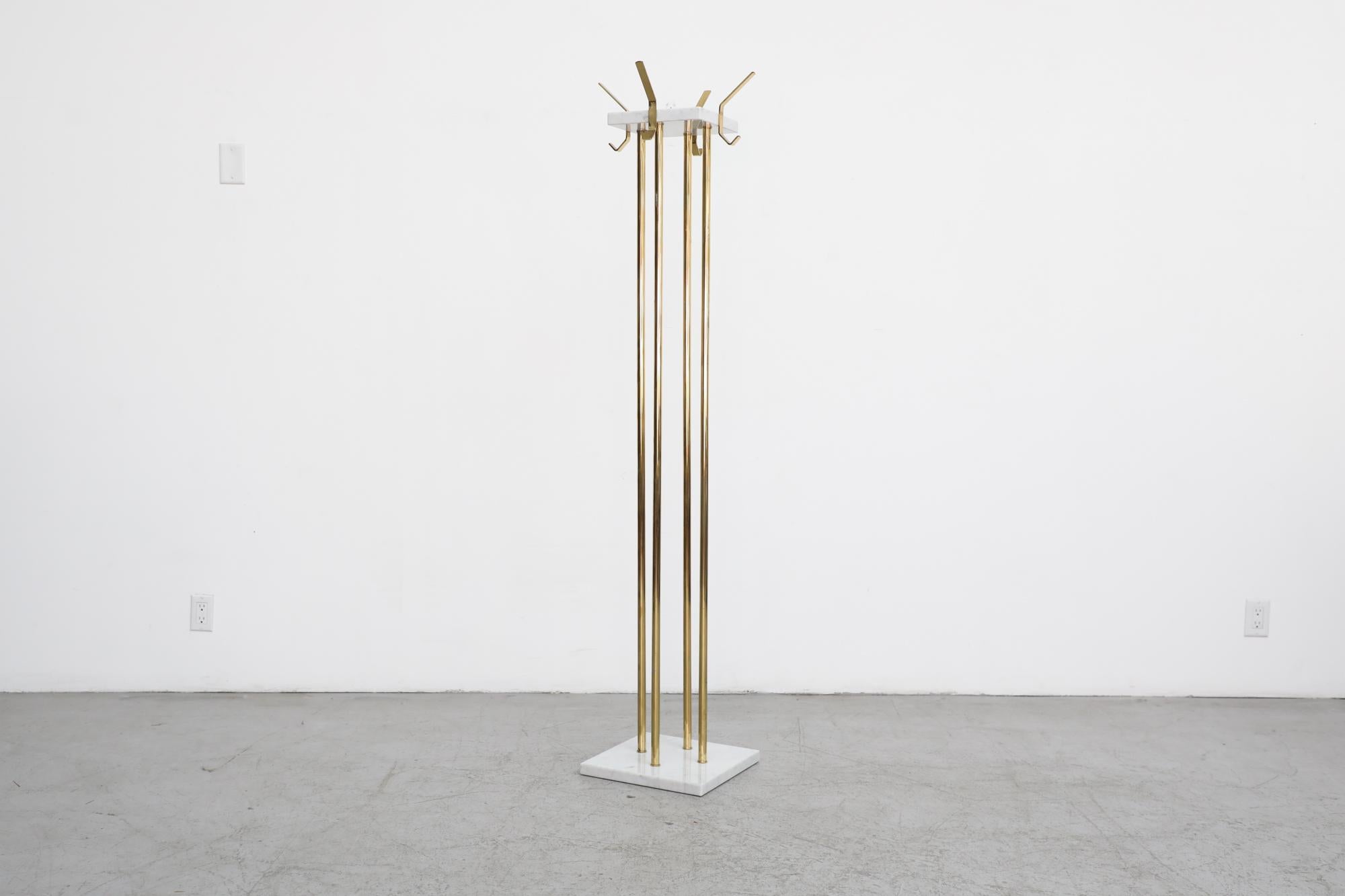 Ettore Sottsass Style Italian coat tree with four brass posts, white marble base and top with brass hooks. In original condition with visible wear including tarnishing of the brass and some pitting. Wear is consistent with its age and use. Brass
