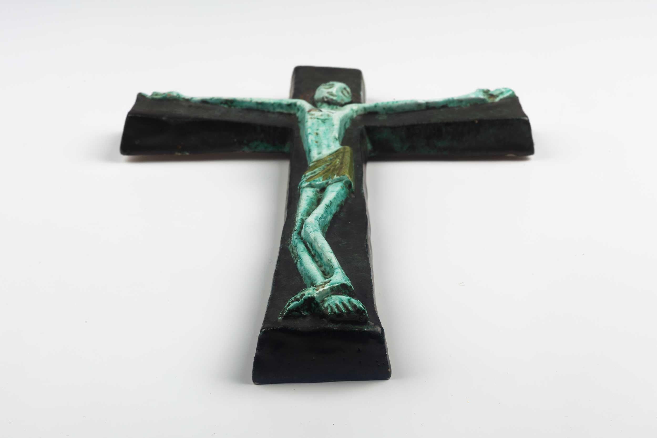 Midcentury European wall cross in blue, green tones with angelic Christ figure in volume. From a large collection of vintage crosses handmade by Flemish artisans. 

From modernism to brutalism, the crosses in our collection range from being as