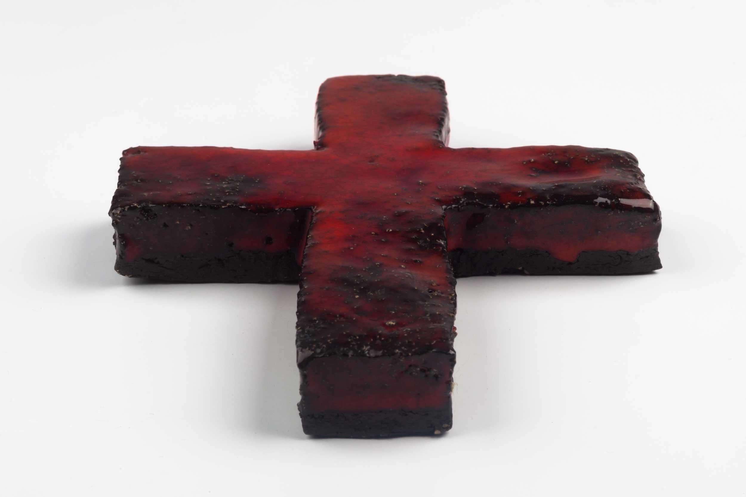 Midcentury European wall cross in textured ceramic, hand painted in red and black with glossy glaze. From a large collection of vintage crosses handmade by Flemish artisans. 

From modernism to brutalism, the crosses in our collection range from