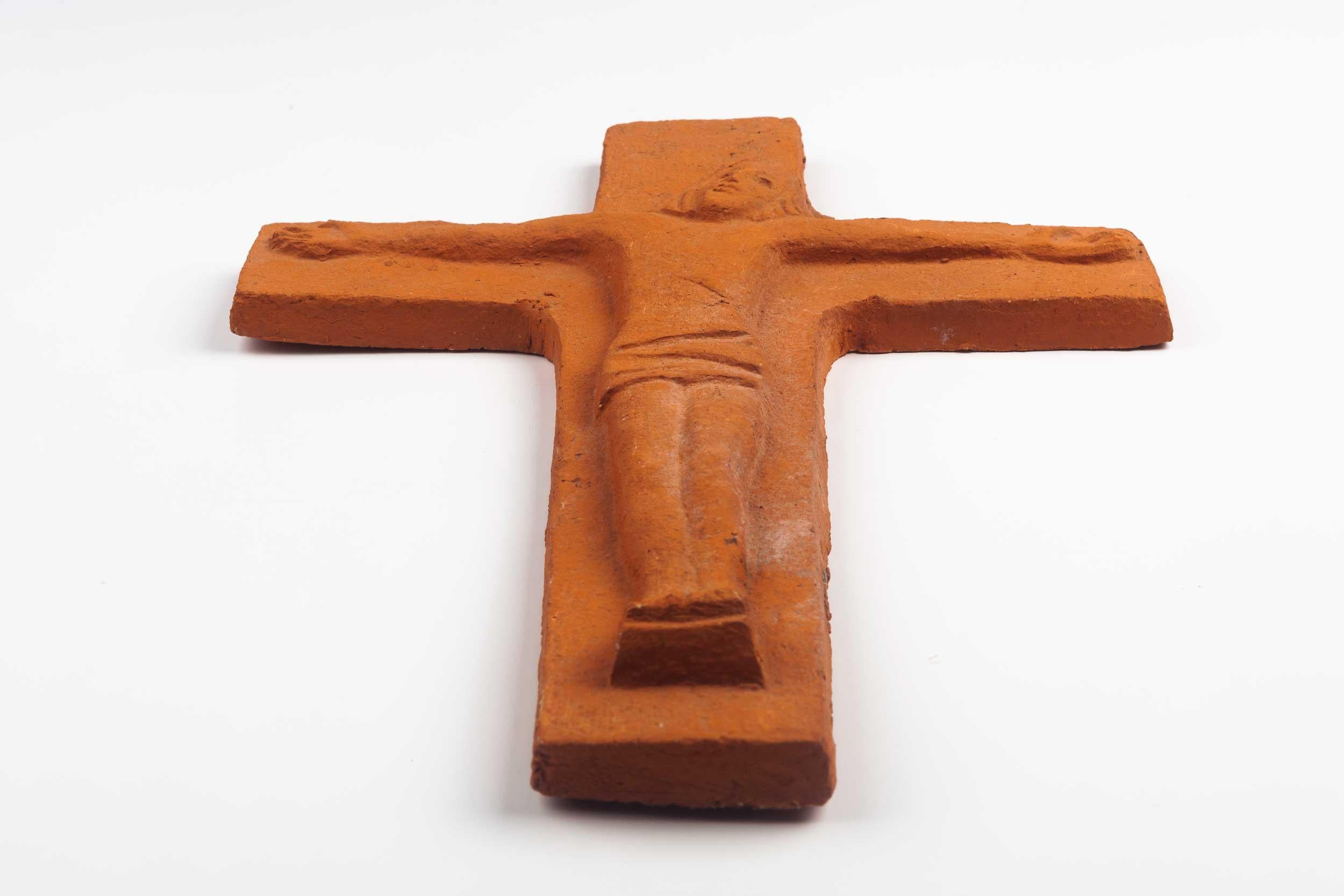 Midcentury European wall cross of natural red clay with Christ figure in relief. From a large collection of vintage crosses handmade by Flemish artisans.

From modernism to brutalism, the crosses in our collection range from being as futurist as a