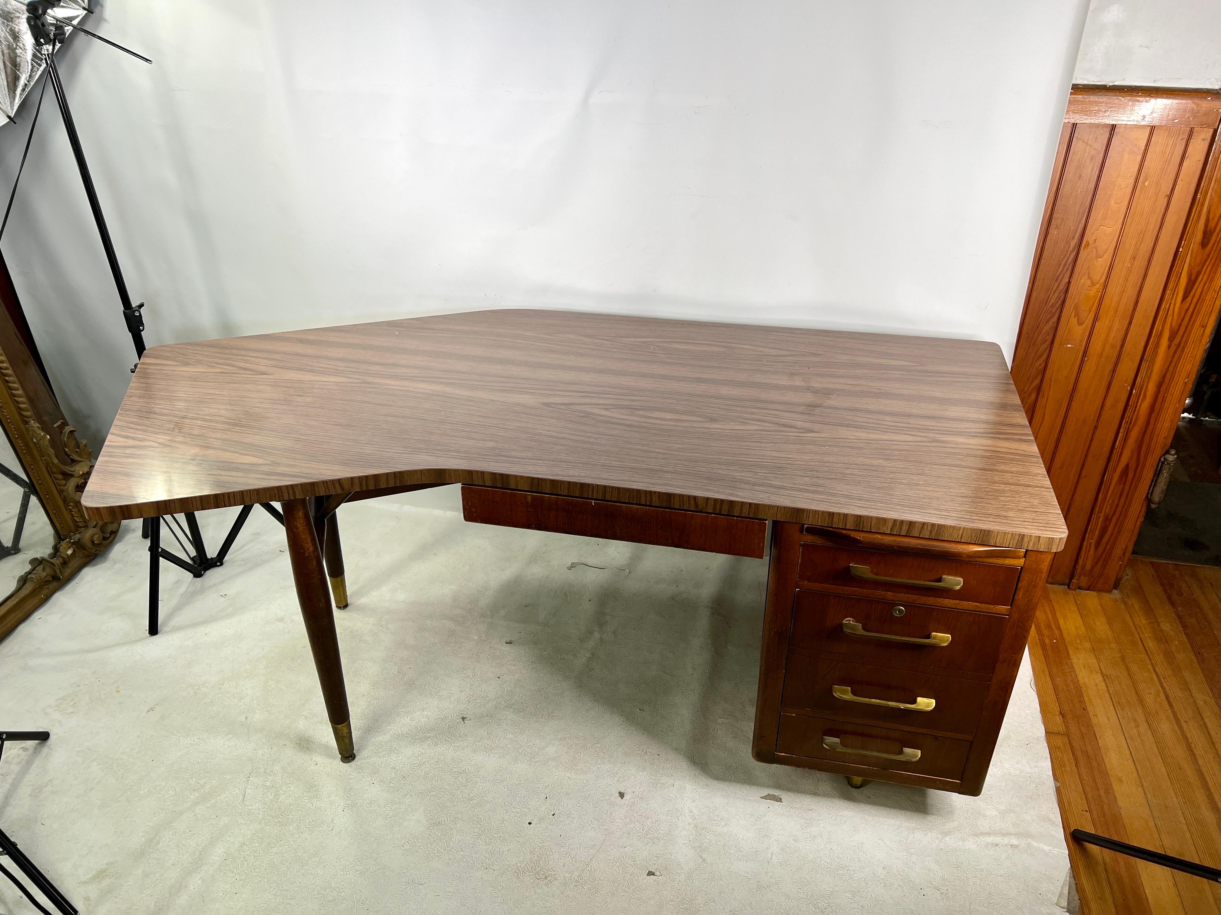 For sale is this very unique large executive boomerang desk. The top is made out of laminate and the bottom is solid wood.