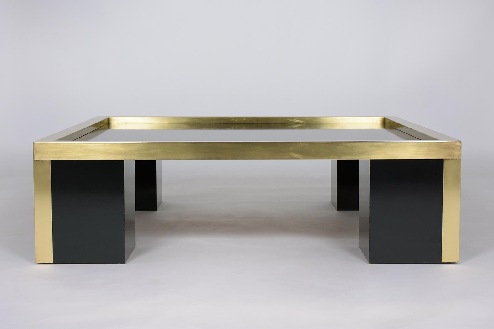Introducing our captivating mid-century modern coffee table, an emblem of the 1960s design philosophy, masterfully brought to life using brass and laminated wood. The result of painstaking craftsmanship, this vintage table stands testimony to the
