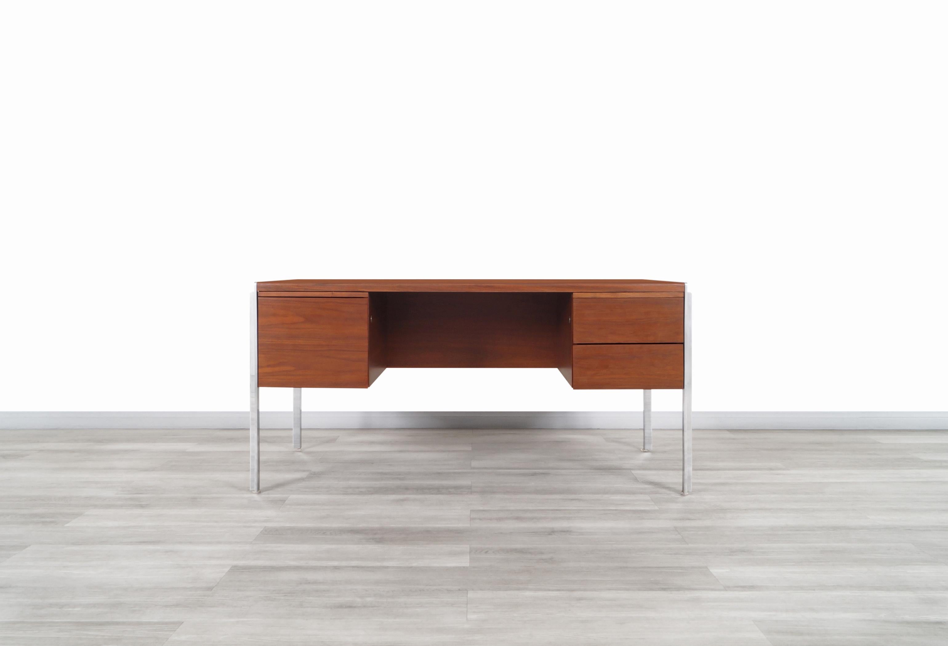 Stunning rare mid-century executive walnut desk manufactured by Stow Davis in the United States, circa 1960s. This desk has been constructed from the highest quality walnut wood and features an avant-garde and functional design. Features a total of