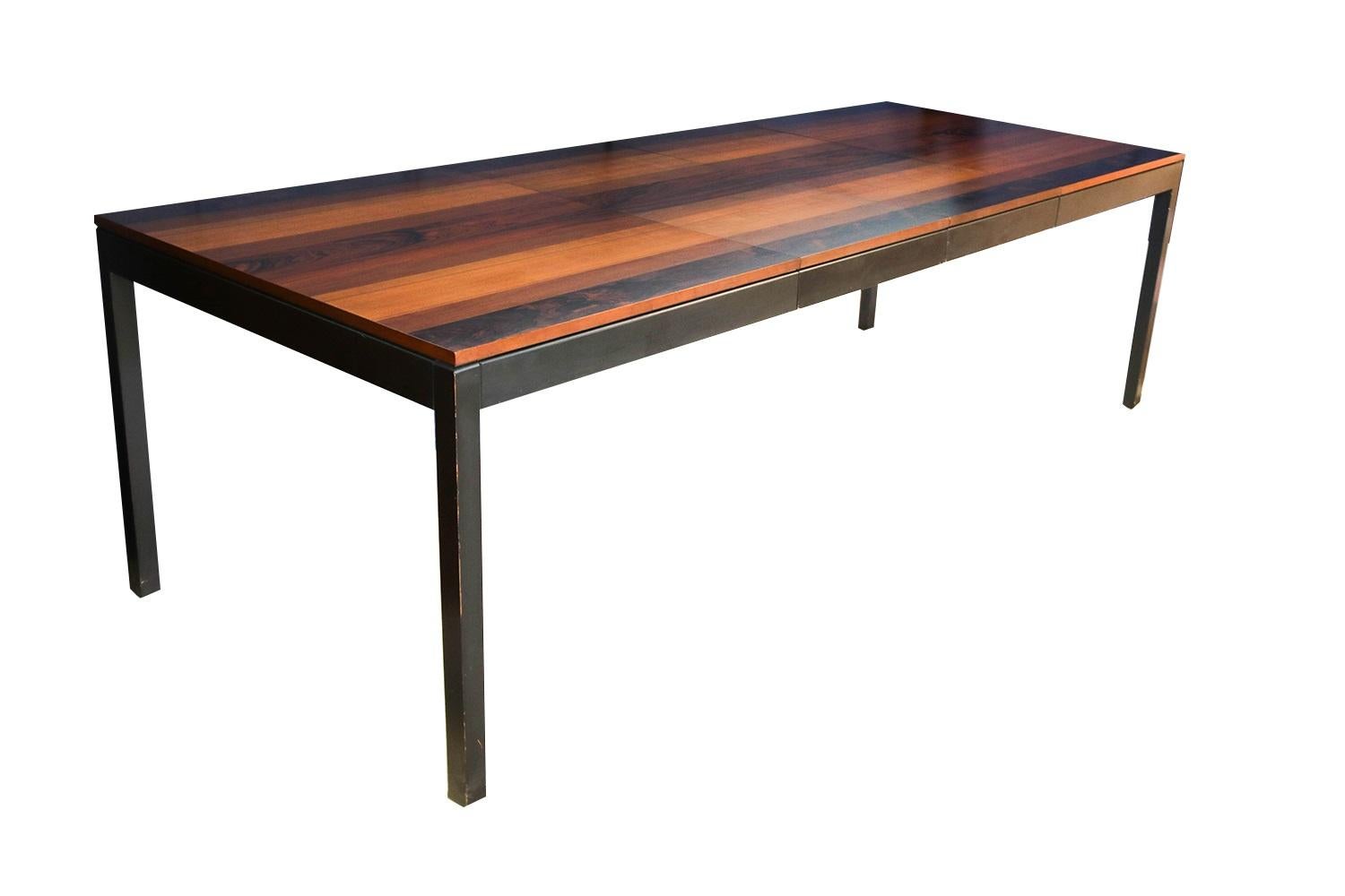 An exceptional Milo Baughman Parsons dining table circa 1960s, by Directional Furniture. This extraordinary table features a striped veneer top of gleaming rosewood, teak and walnut with smooth clean lines characteristic of classic Danish design.