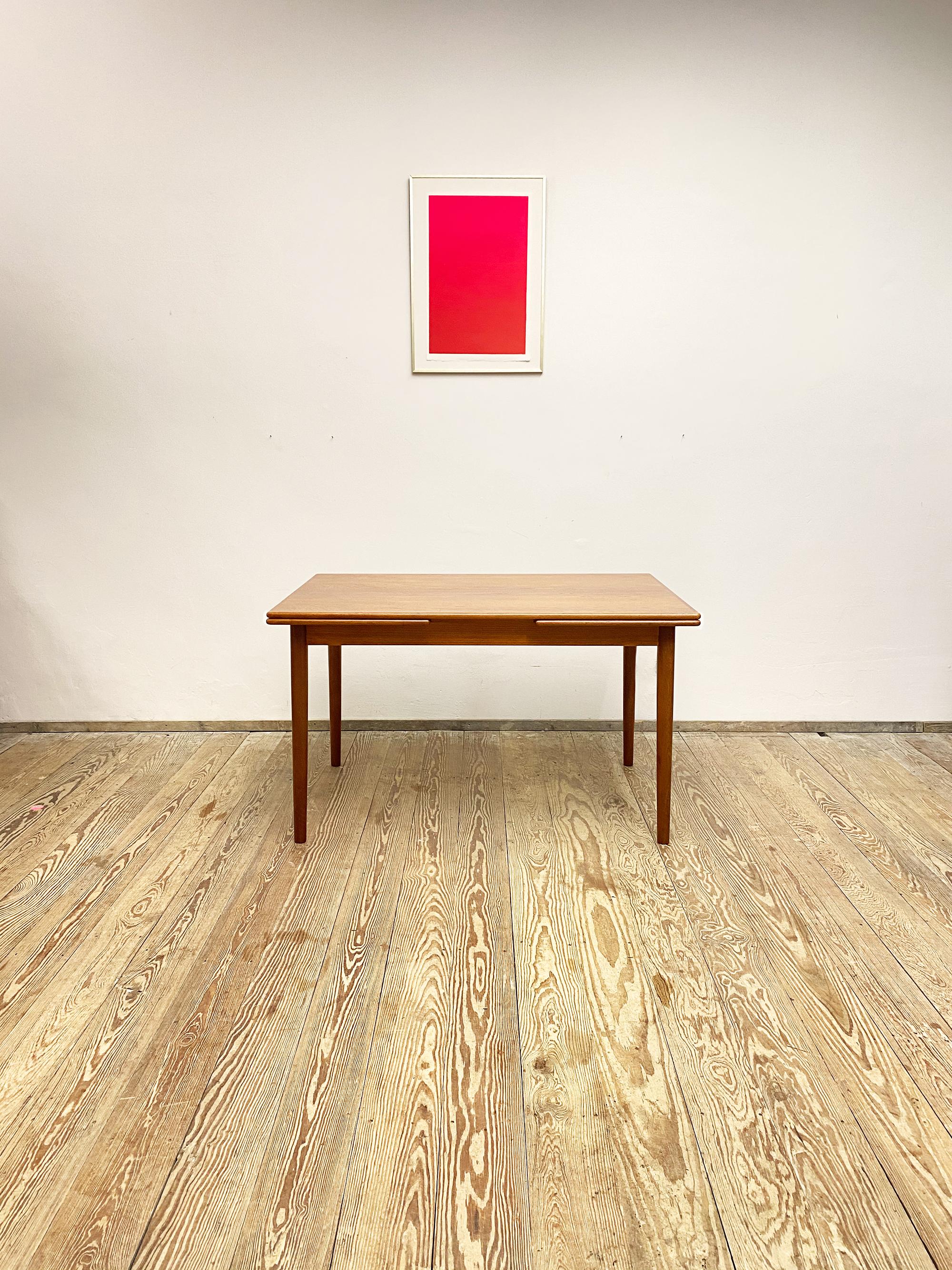 Dimensions 125 / 172,5 / 220 x 80 x 72 cm (Length x Depth x Height)

Elegant dining table made by Gudme Møbelfabik in Denmark. This table is made out of teak wood and comes with tapered legs and two pull out leaves that can be used to extend the
