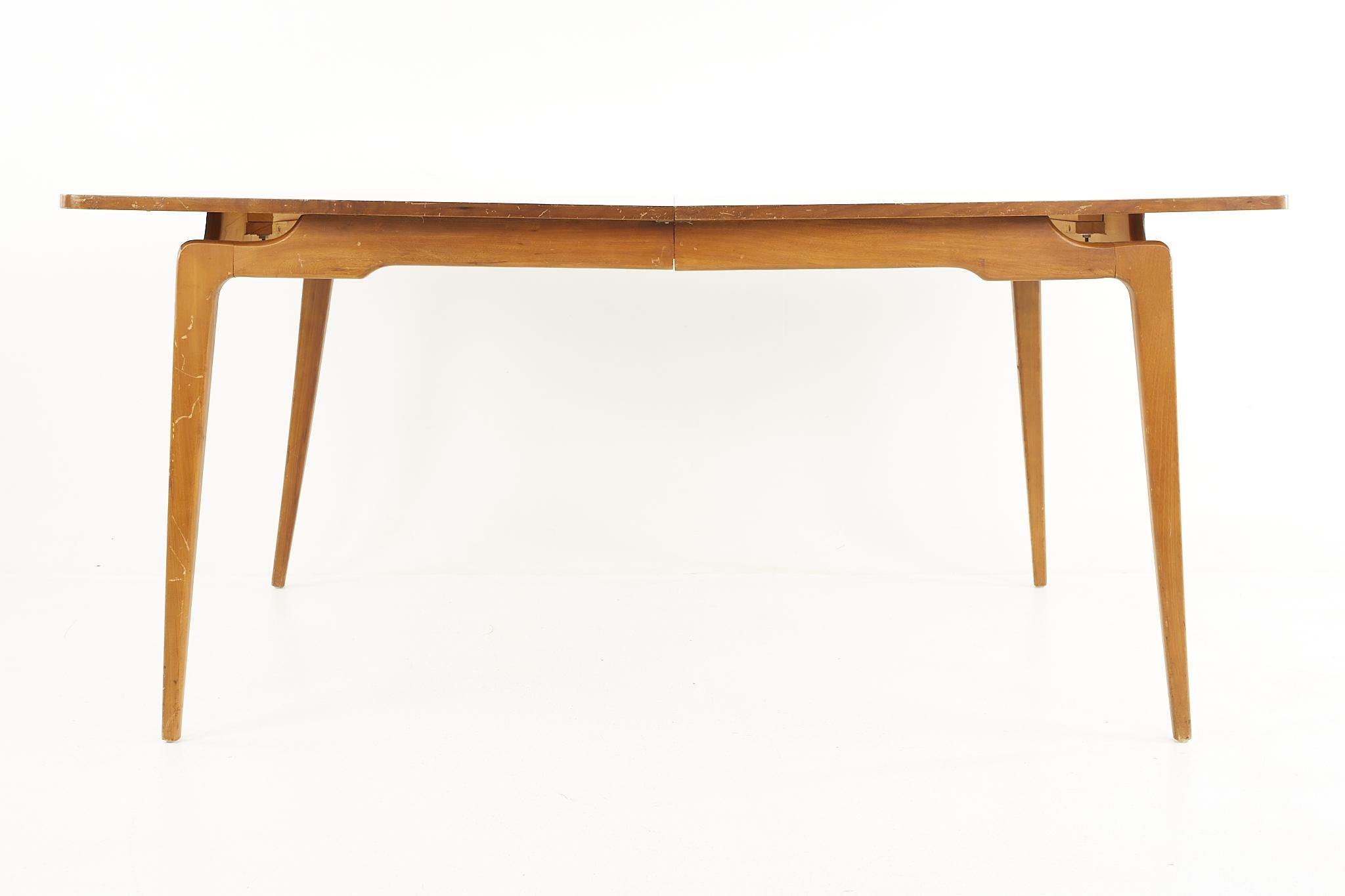 Mid Century Expanding Walnut Dining Table with 2 Leaves

This table measures: 66 wide x 42 deep x 30 high, with a chair clearance of 26 inches, each leaf measures 18 inches wide, making a maximum table width of 102 inches when both leaves are