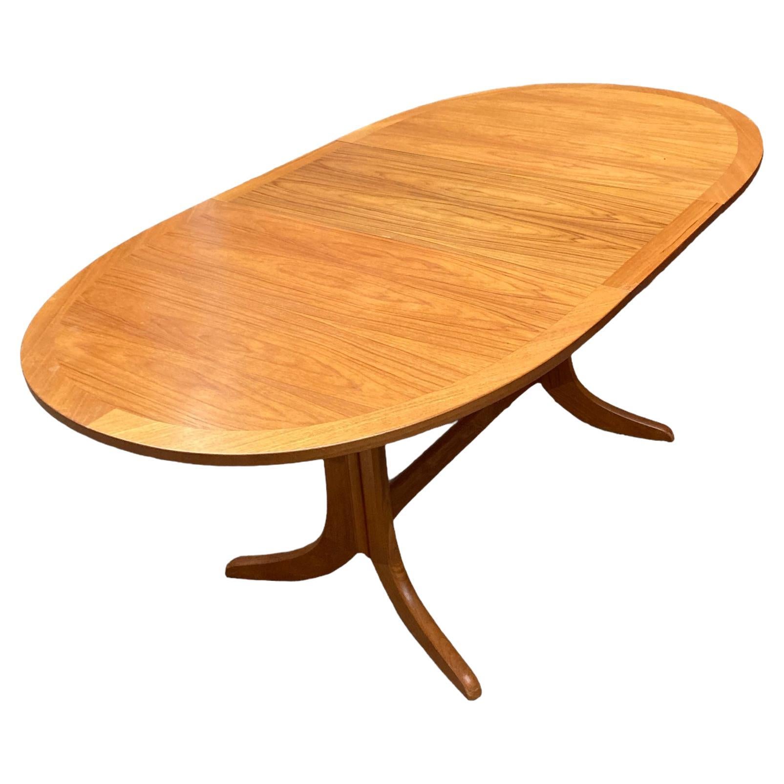 Mid Century Extendable teak butterfly Oval dining table made by Nathan. For Sale