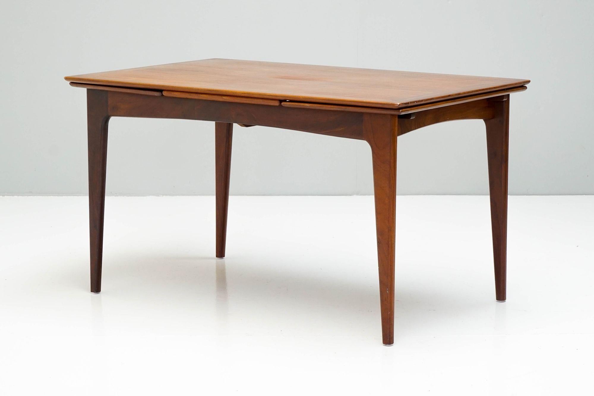 Mid-Century Dining table by A.Younger, in dark Afromosia Teak, great overall condition, very slightly faded area in the middle of the top leaf. Cleaned and polished.
