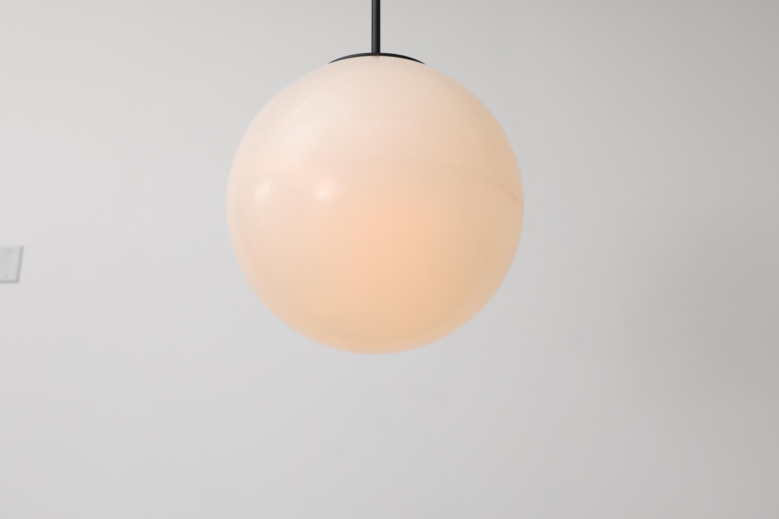 Mid-Century Extra Large Acrylic Globe Pendant Light with Black Enameled Hardware In Good Condition For Sale In Los Angeles, CA