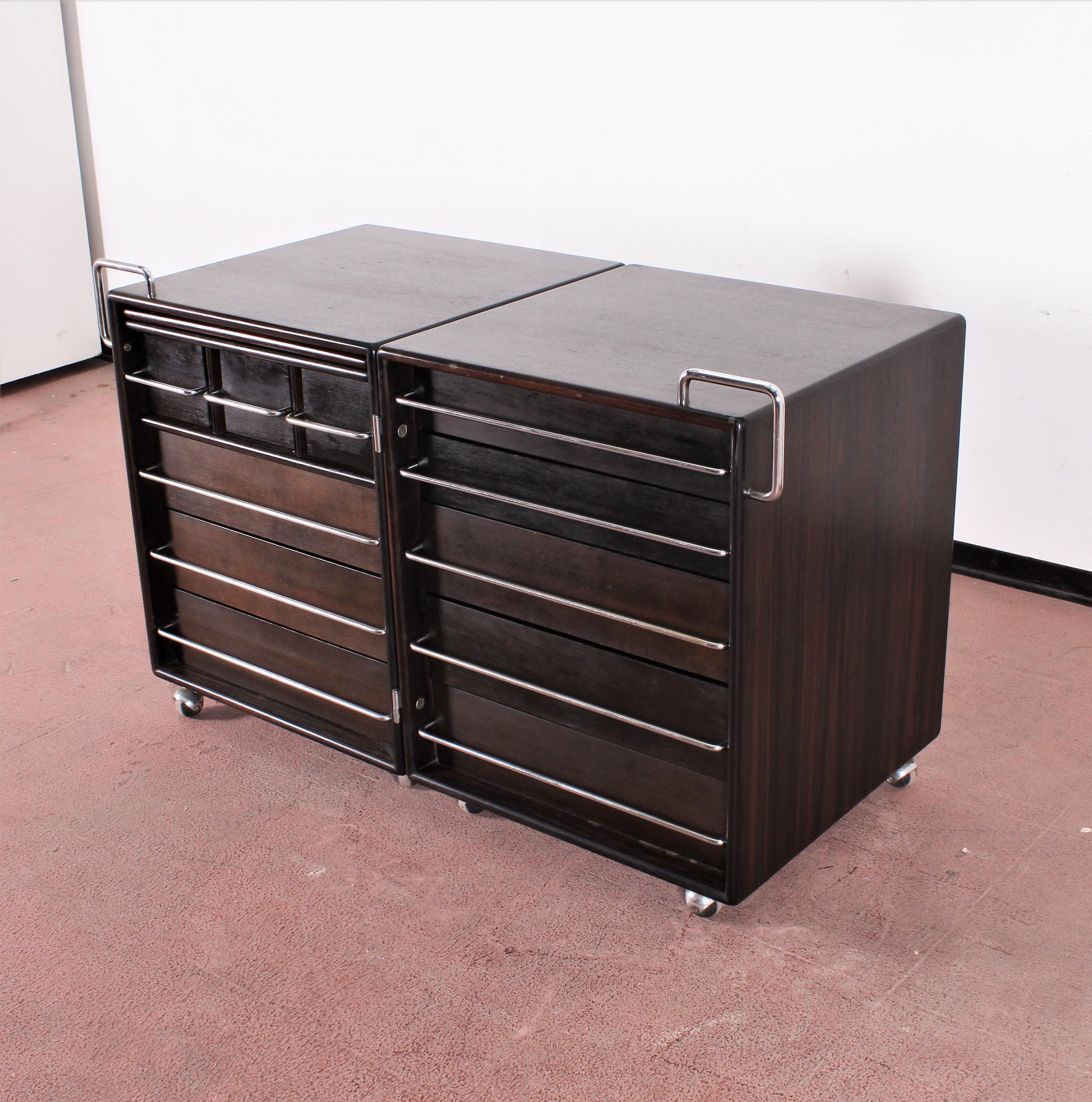 Beautiful chest of drawers with dressing table, with two compartments on wheels, connected  by hinges, opening with a compass.  Realization in  dark solid wood with chromed steel handles . Designed by Fabio Lenci, produced by Bernini in the