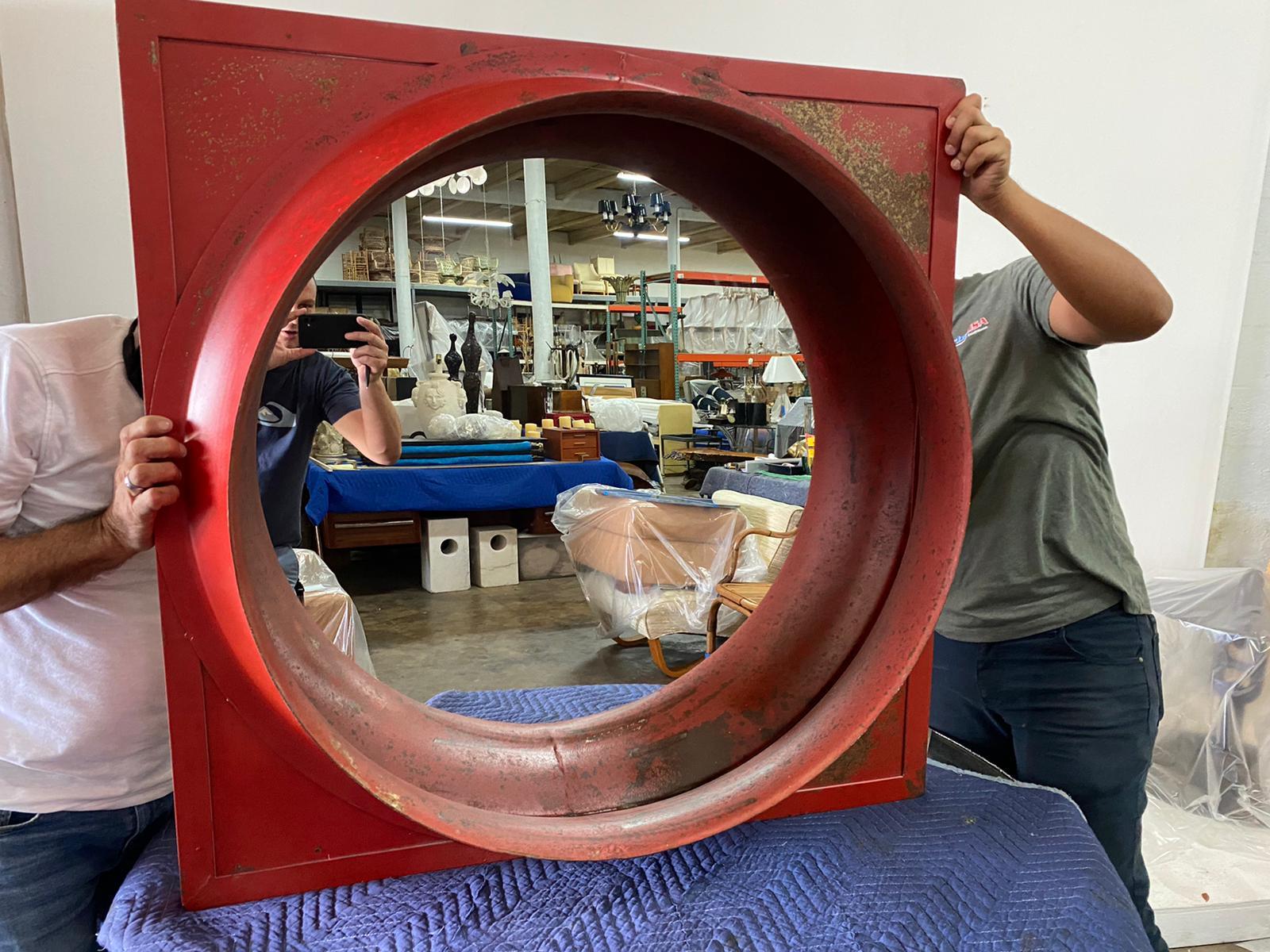 This wonderfully sculptural preserved piece of Americana factory remnant converted to a fun and practical wall mirror in original distressed vibrant red. This has been clear lacquered to preserve the color and prevent any further aging or