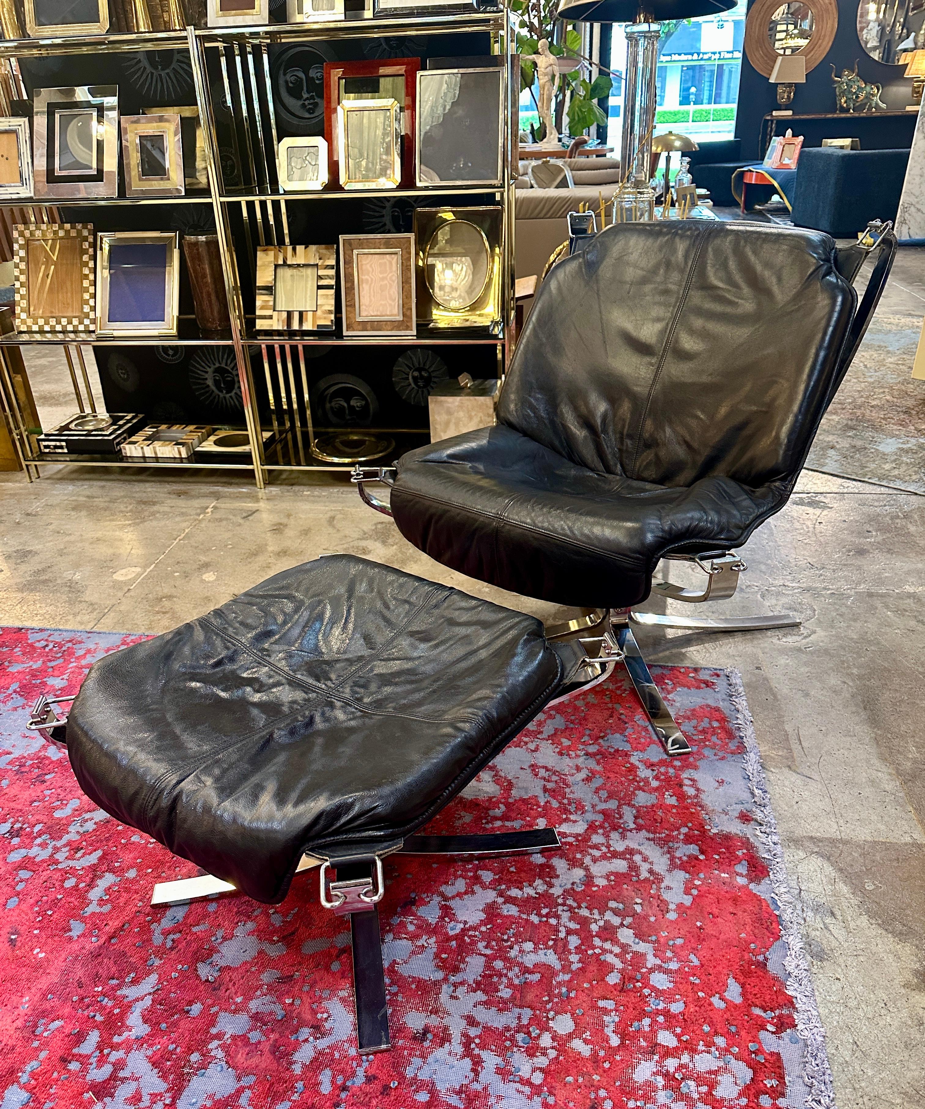 These are stylish and distinctive Falon chairs, showcasing a luxurious yet modern design. The chairs feature deep, black leather cushions with a soft, worn texture that gives them a comfortable, inviting appearance. The leather upholstery is
