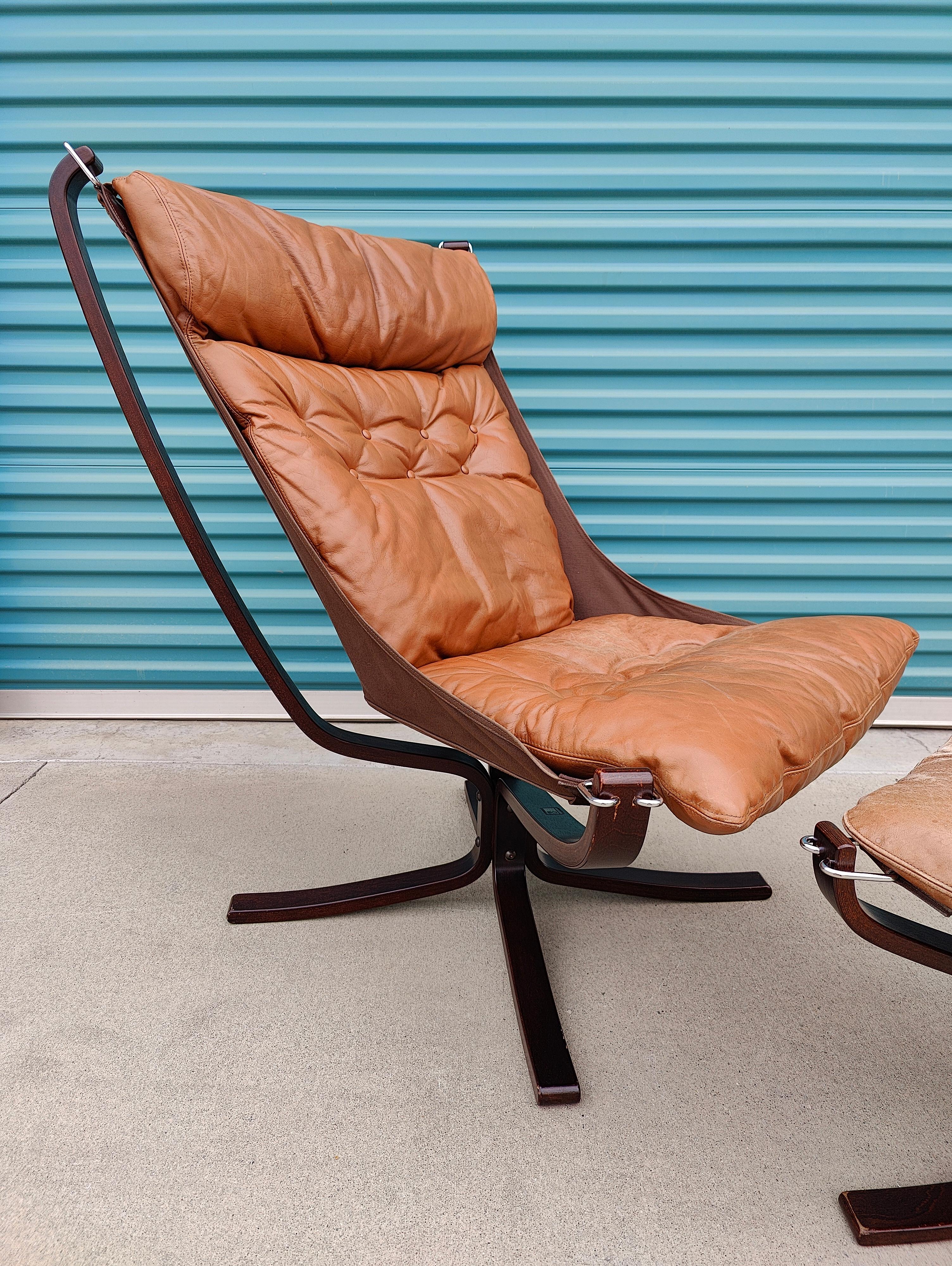 Falcon chair by Sigurd Ressel for Vatne Mobler, circa 1970s. Leather on chair is in great condition with good amount of patina. Ottoman has some wear and two buttons missing on the cushion. Sling in great shape. Tagged with original labels. Chair
