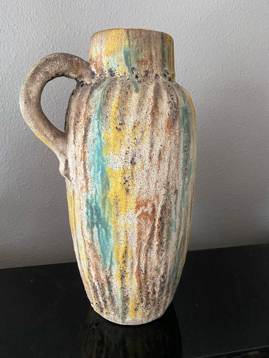 Stunning vase from Scheurich Keramik. This is the first time that I have seen this pattern and rough fat lava glaze with soft blue/green, yellow and brown.
Bit of a brutalist vase. Unique piece. 
