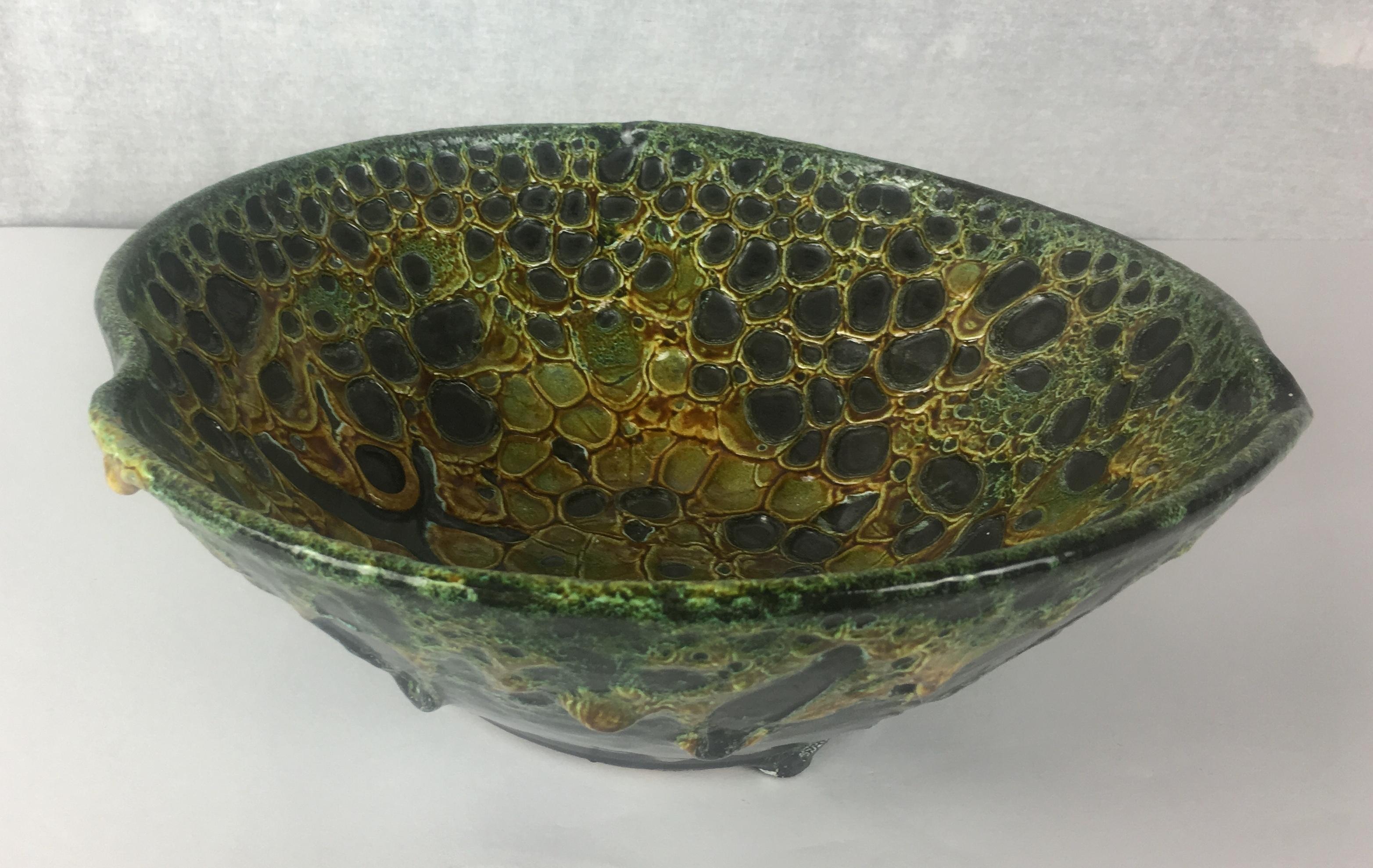 The distinctive glaze on this stunning bowl was developed by Charles Cart the founder of the Le Cyclope Pottery brand in Annecy-le-Vieux in the Haute Savoie area of France. The firing process reveals the black layer below the multicolored glaze in a