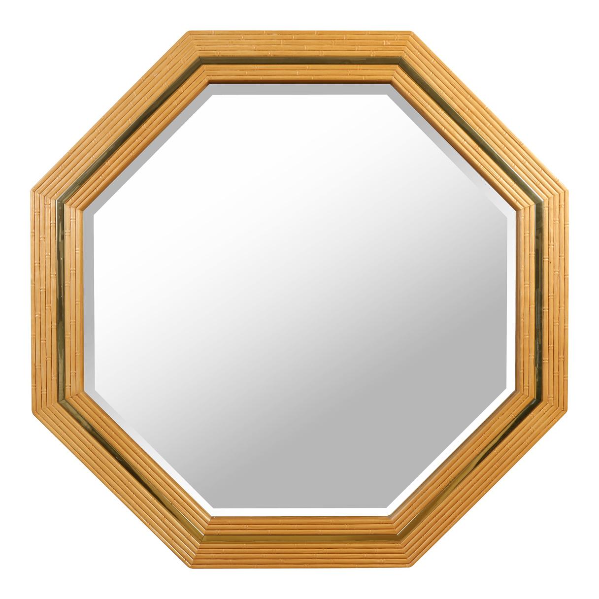 An octagonal, mid-century style, faux bamboo and brass wall mirror.  Crafted of reeded oak to resemble bamboo with a brass detail inset.  