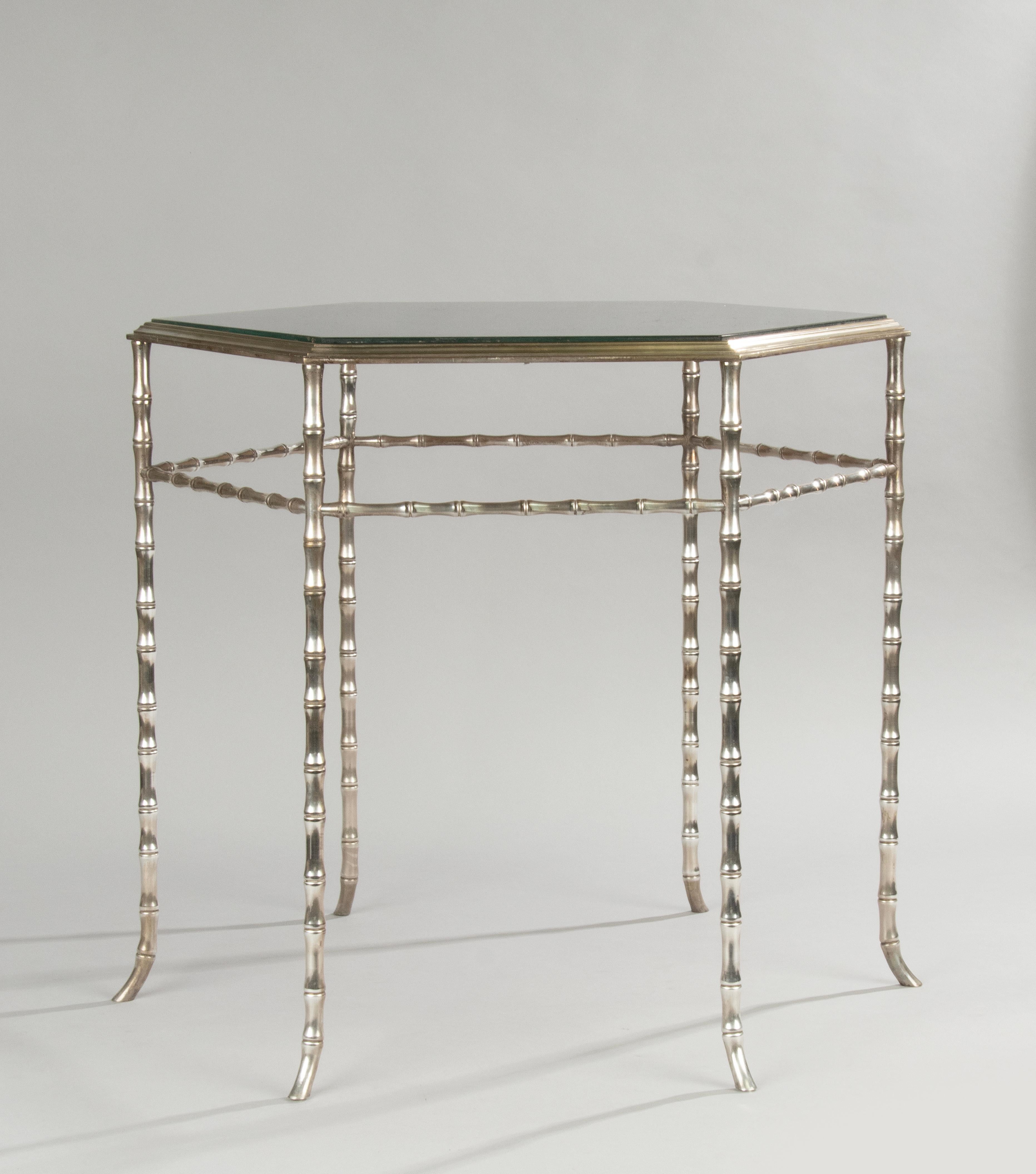 A stylish faux bamboo Hexagonal coffee or side table, attributed to Maison Baguès, France. The base is made of nickel plated solid brass. With a smoked glass top. In good and stable condition. Made in France, around 1960-1970. 
Dimensions: 55 (h)