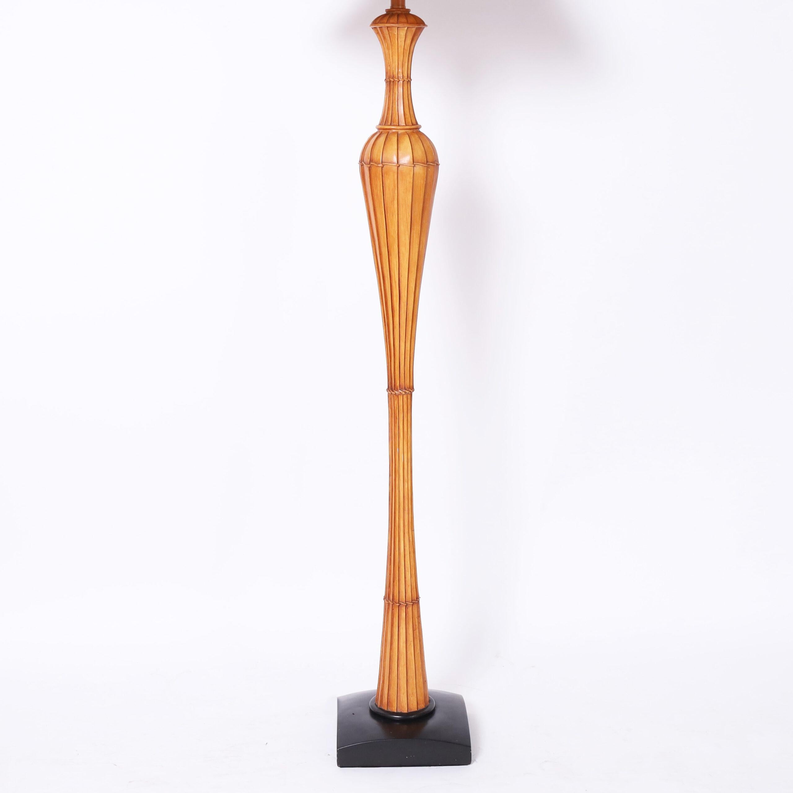 Chic mid century floor lamp with a bamboo shade and faux bamboo composition column on a black lacquer base.