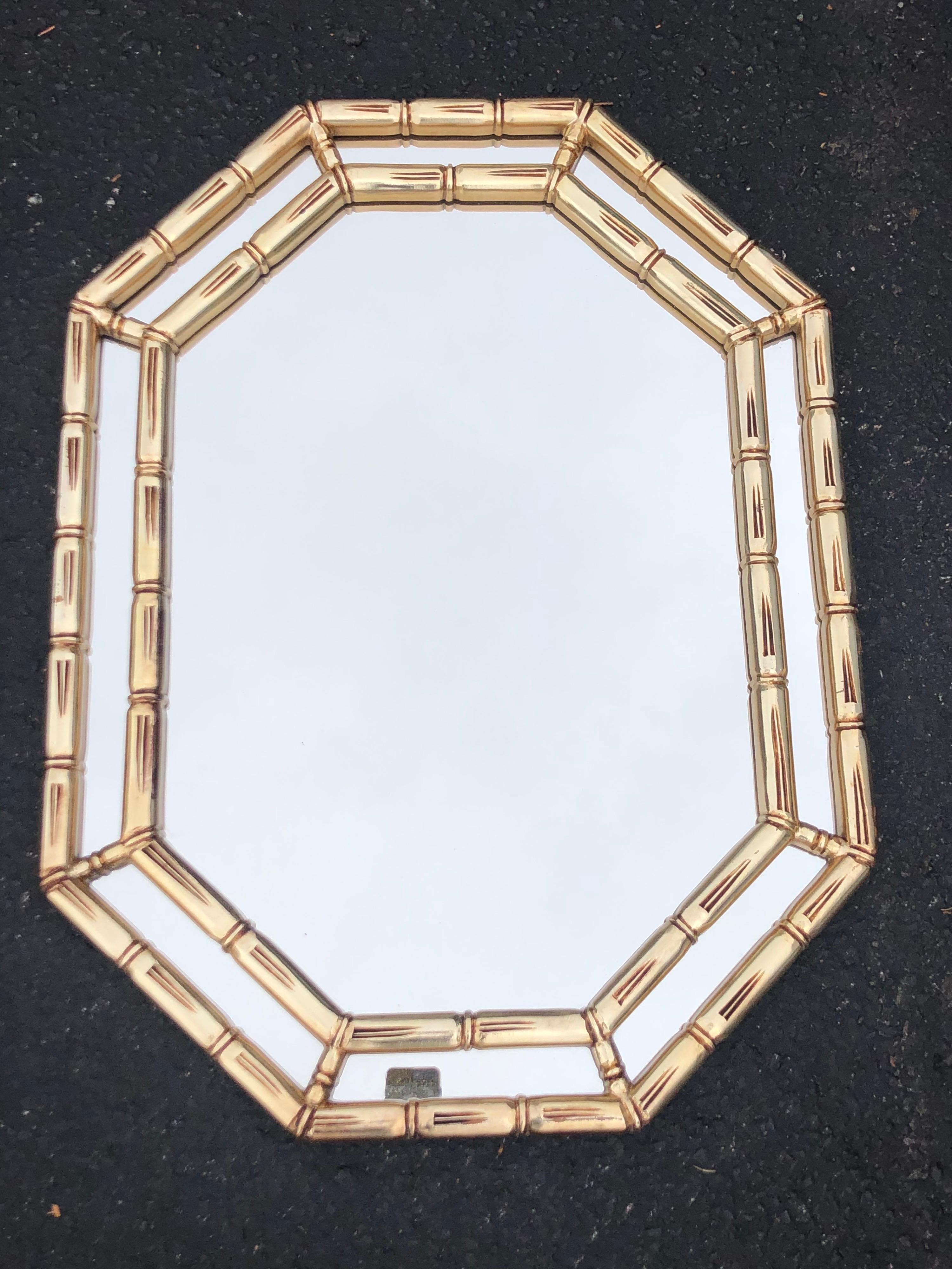 Mid Century faux bamboo mirror in gold. Classic design and perfect size for a powder room.