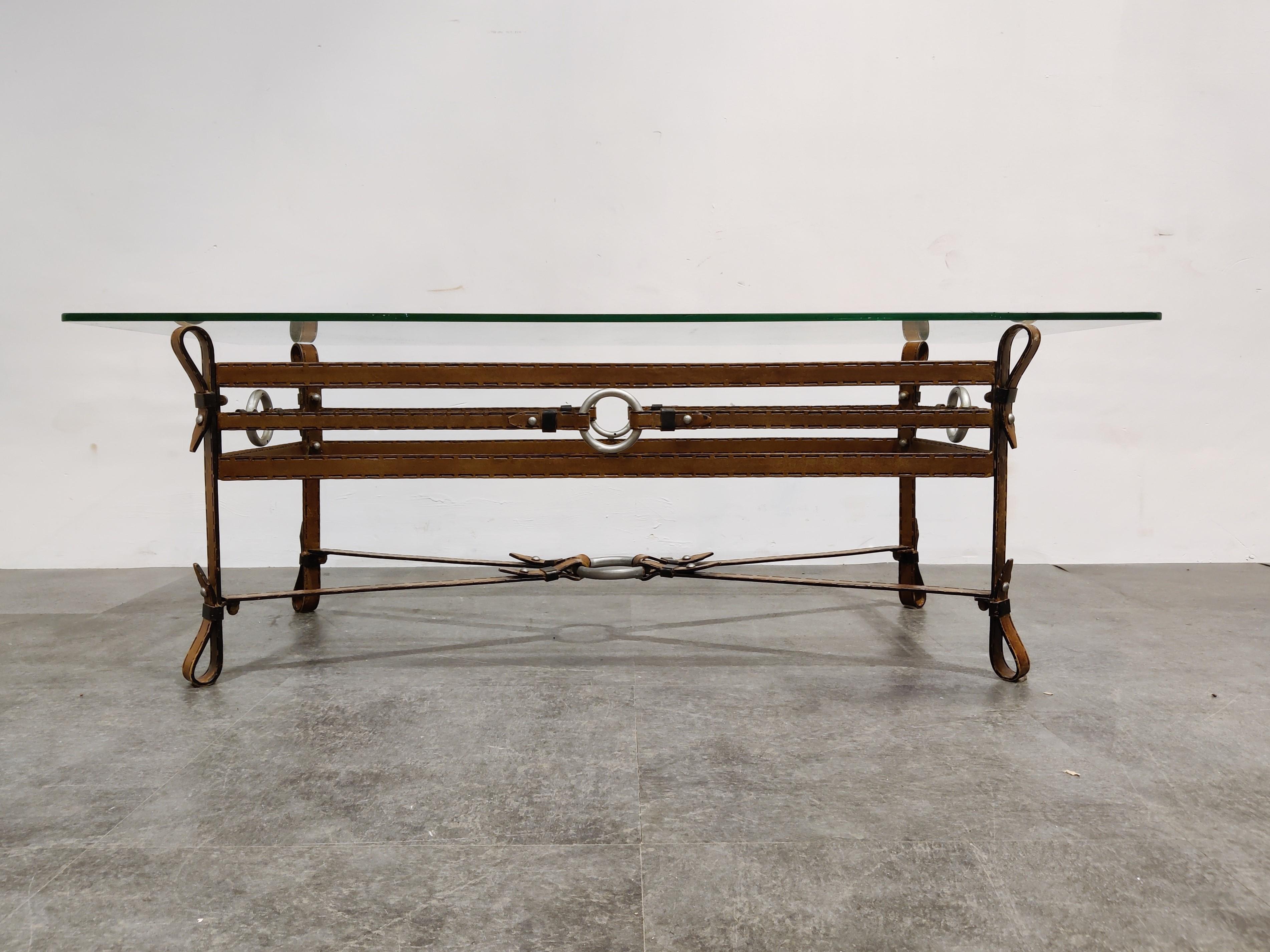Beautiful coffee table made from iron and glass.

Unique and well thought out faux leather base made from metal

You could not tell it isn't real leather until you touch it.

Clear glass top.

Good condition

Design in the manner of