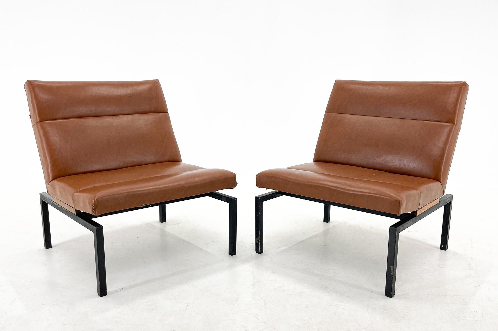 Vintage design lounge chairs in industrial style. Made of faux leather with metal legs and wooden detail. Suitable for new upholstery. Up to 4 pieces available.