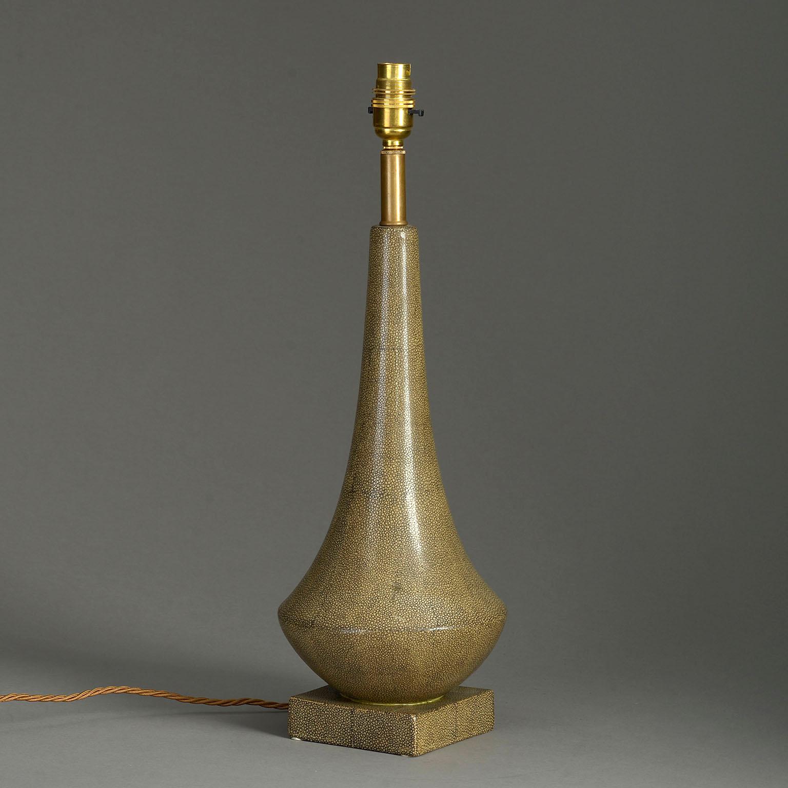 A mid-20th century faux shagreen glazed ceramic table lamp, the vase shaped stem set upon a square plinth.

Dimensions refer to ceramic parts.

Shade not included.