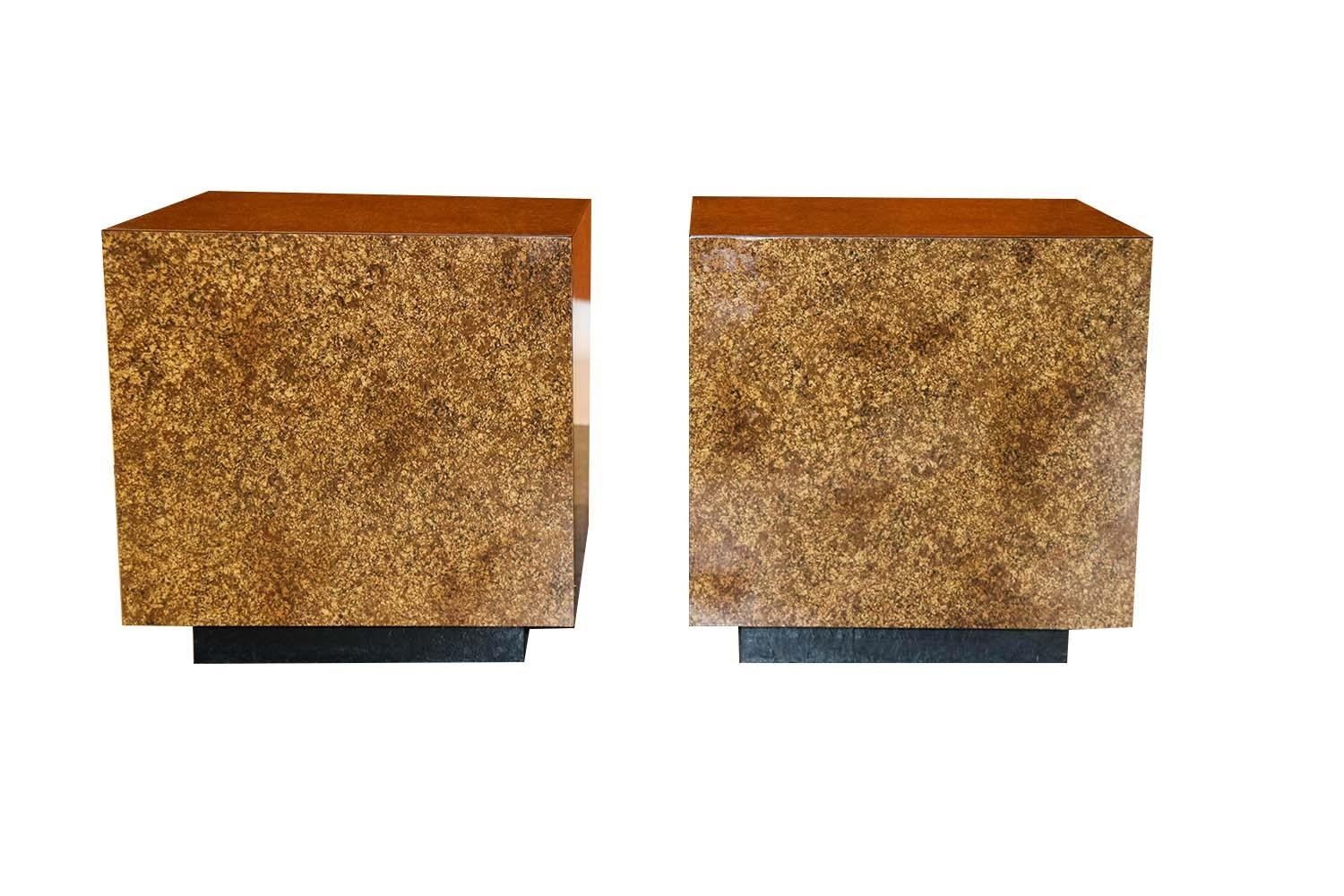 A beautiful pair of Modernist, faux tortoiseshell cube side tables, in the style of Milo Baughman. Features faux tortoiseshell oil drip finish, stylish striking design on all sides showcasing the faux tortoiseshell painted finish, each rest on an