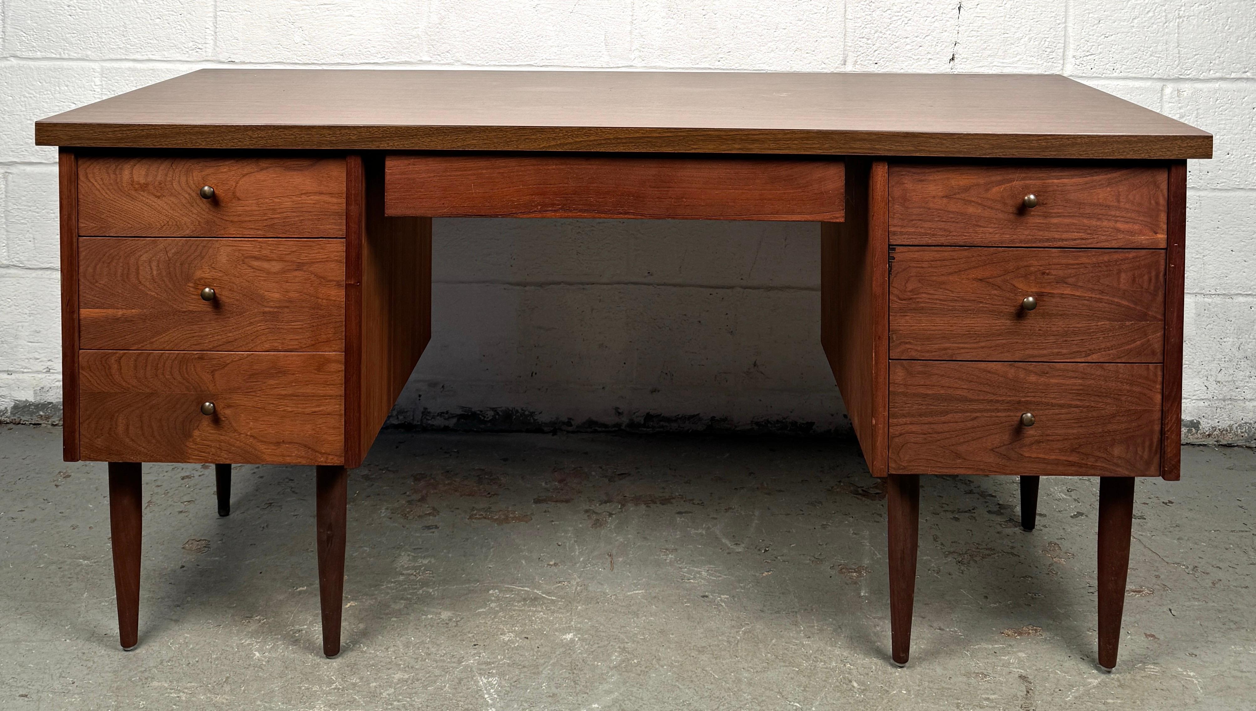 Add a touch of vintage charm to your workspace with this mid-century faux wood laminate desk, a perfect blend of retro aesthetics and practical durability. Featuring the clean lines and minimalist silhouette typical of the era, this desk offers a