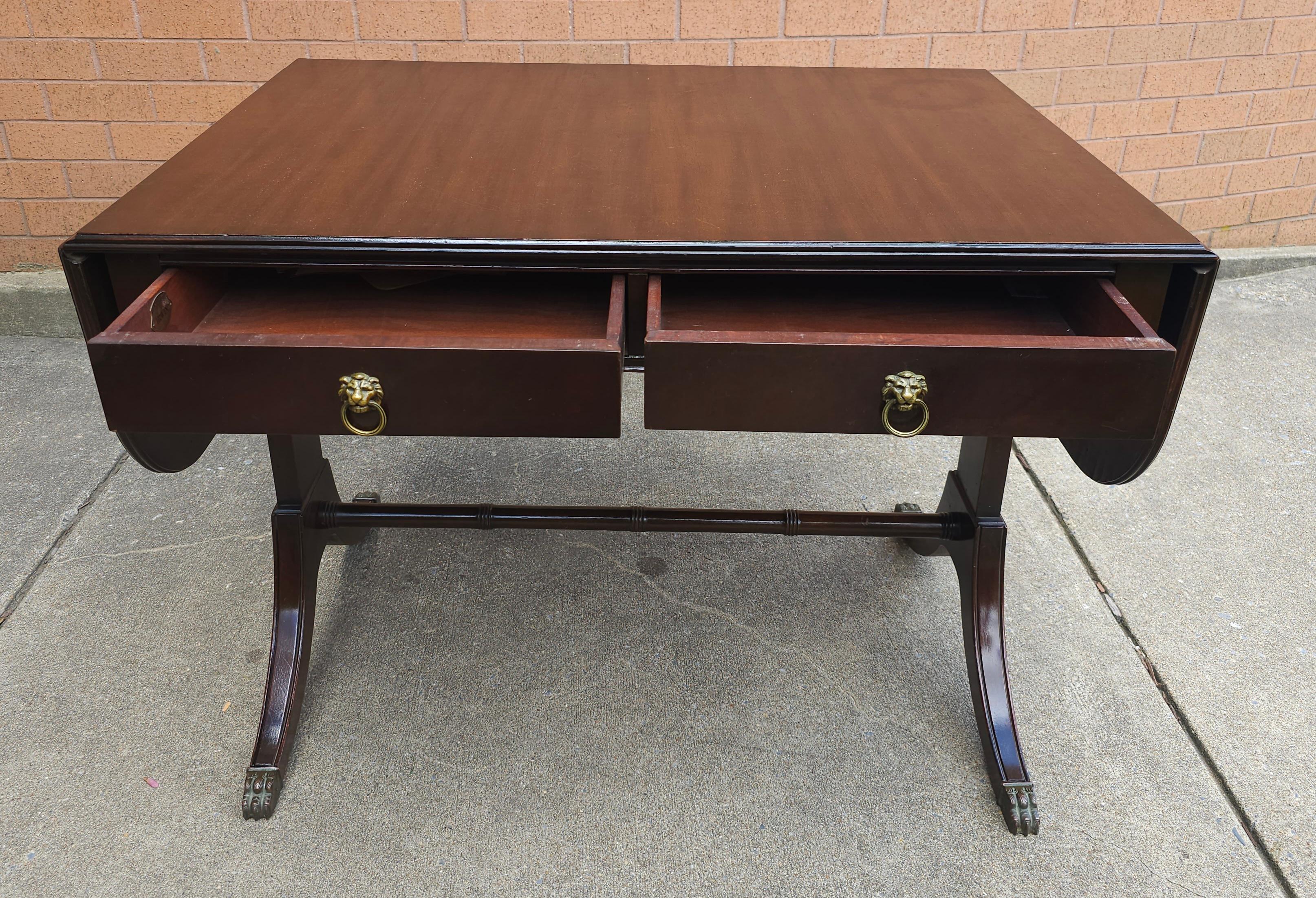 A Mid Century Federal Style Mahogany Trestle two drawer Drop Leaf Table. Measures 56.25