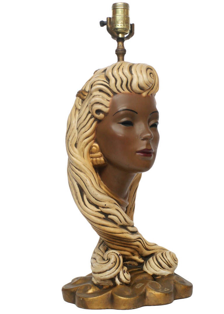 Mid-century chalkware lamp featuring a detailed sculptural bust of a young girl with long blonde curly hair and gold accessories.

