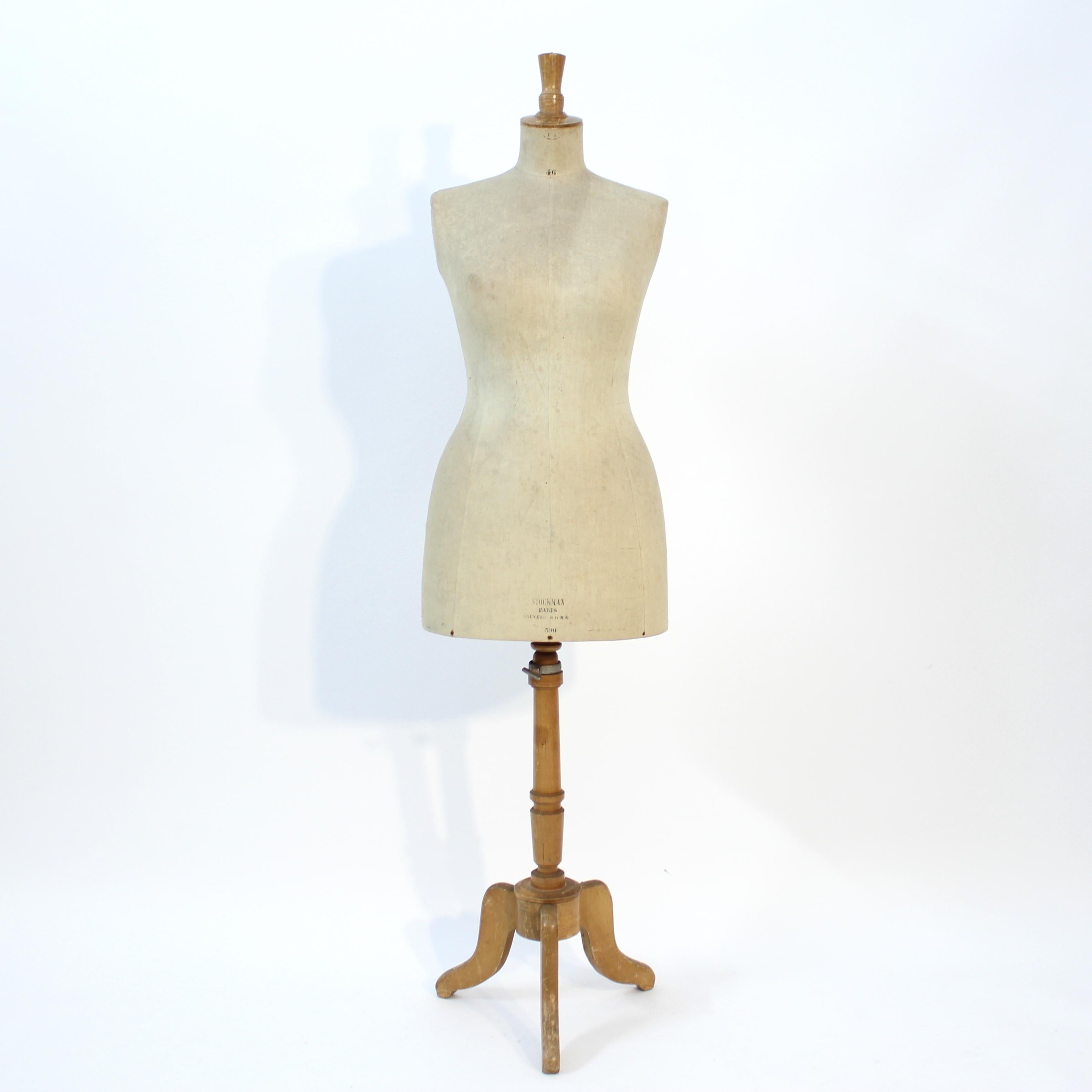 Very decorative female mid-century mannequin made by Siegel for Stockmann, Paris, size 46. The torso stands on a tripod wooden base of birch or beech. The whole construction is demountable. Good and honest condition with normal patina and ware 