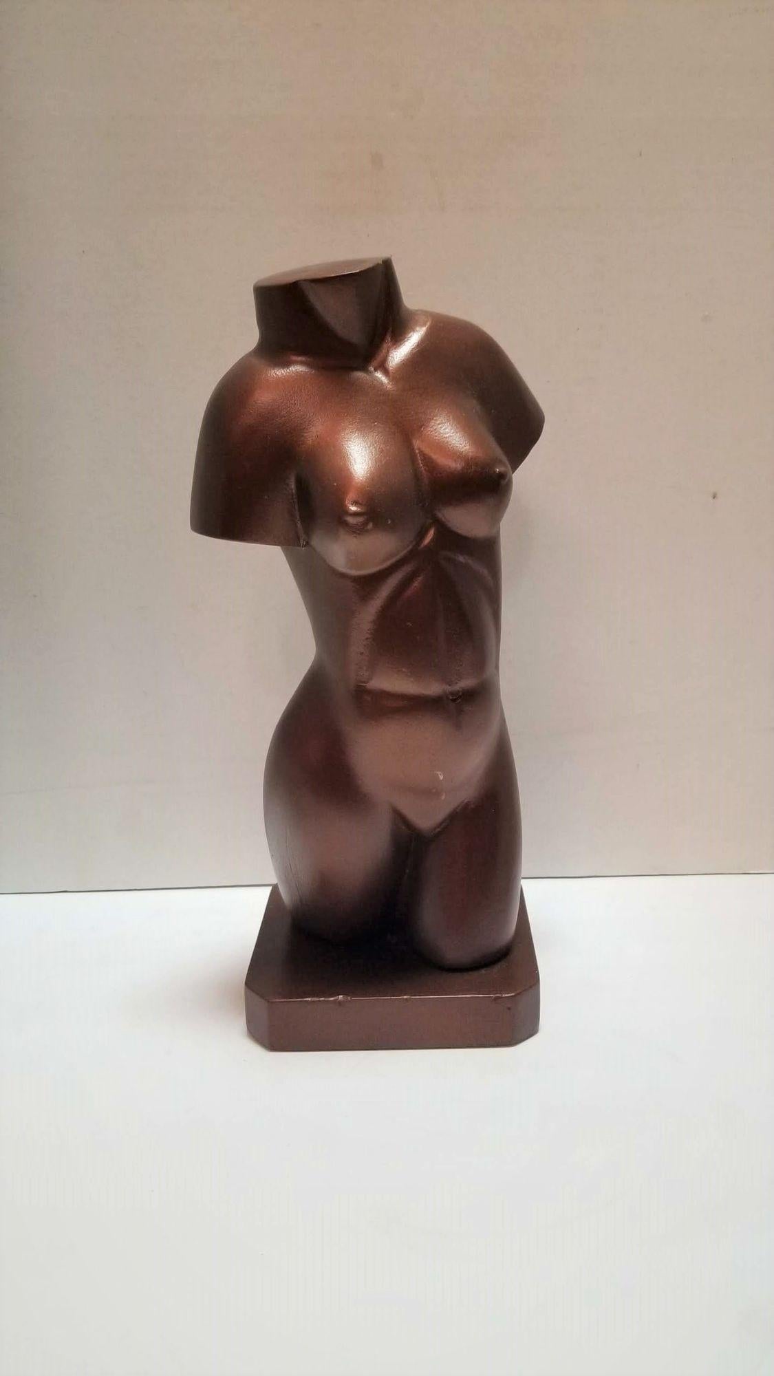 Wooden Statue of Nude Female Bust in Bronze Finish
A vintage wooden sculpture of a female nude bust painted bronze that captures the essence of the female form. The use of wood as the primary material adds a lightweight quality, while the painted