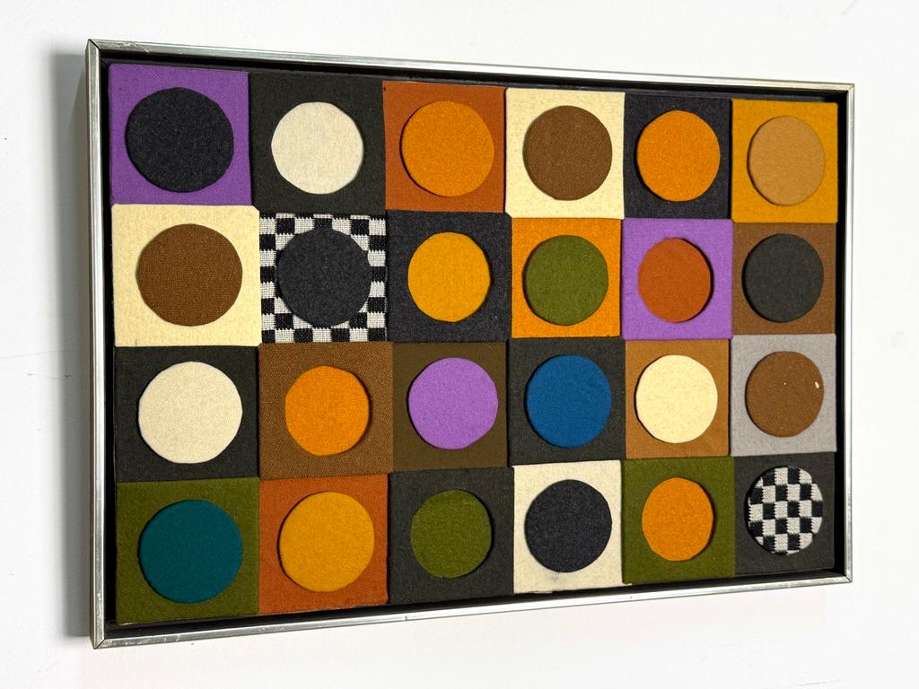 Incredible textile wall hanging sculpture by Michigan fiber artist Carolyn Vosburg Hall

Multi dimensional constructionist piece in colorful textile wrapped shapes with black and white checkerboard accents

Titled 