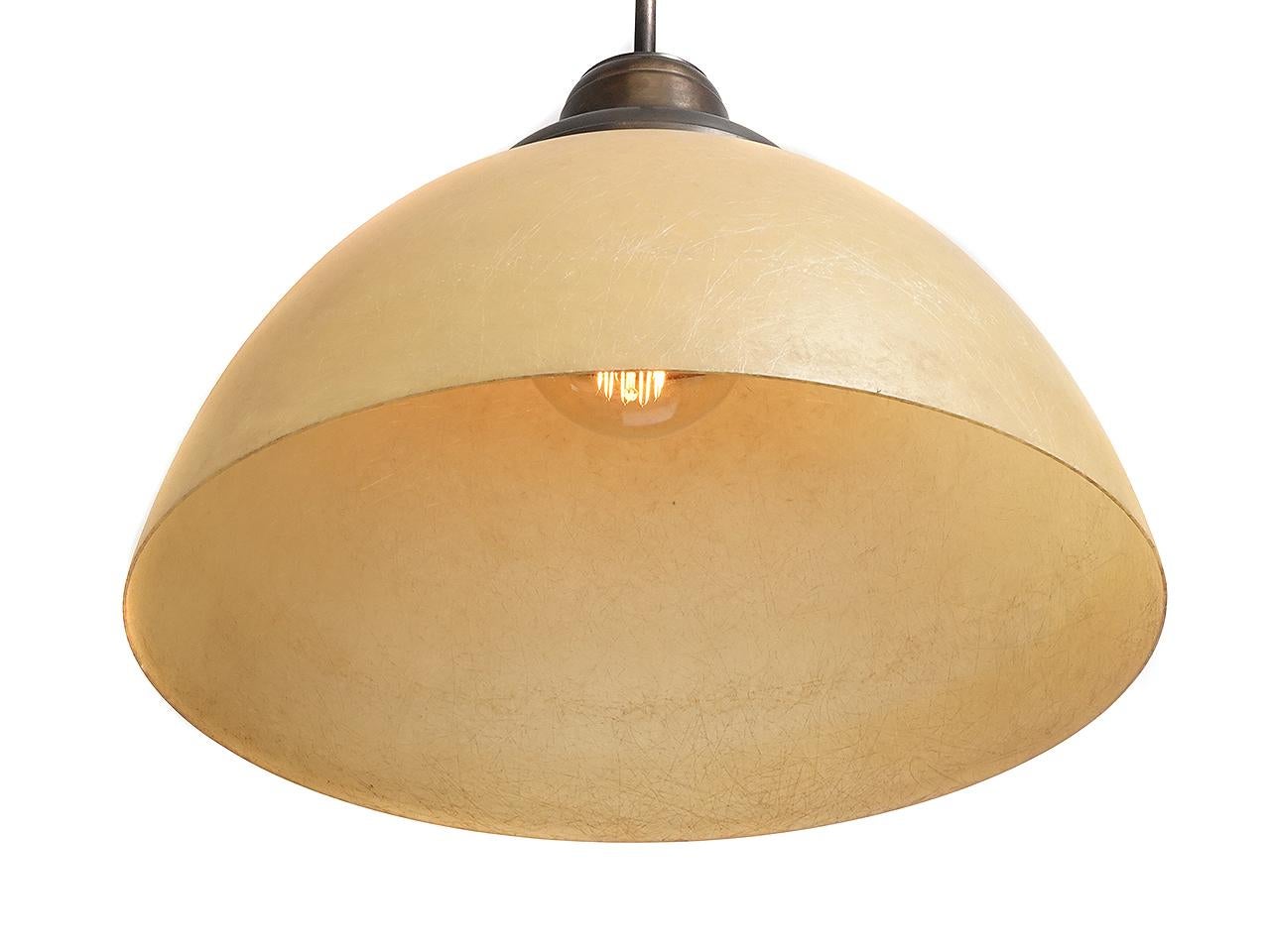 These fiberglass domes date to from the 1950s. We recently found a nice barn collection of these originals. When lit they give off a nice warm glow and feature the fiber texture. The new socket and shade holder combined with the early shade make a