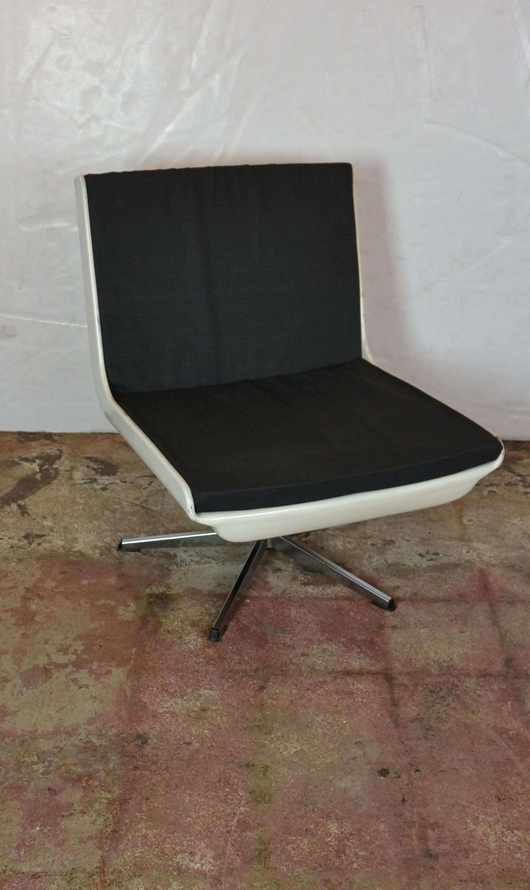 Midcentury swivel fiberglass lounge chair. The cushions are loose and covered in a black color tin fabric.