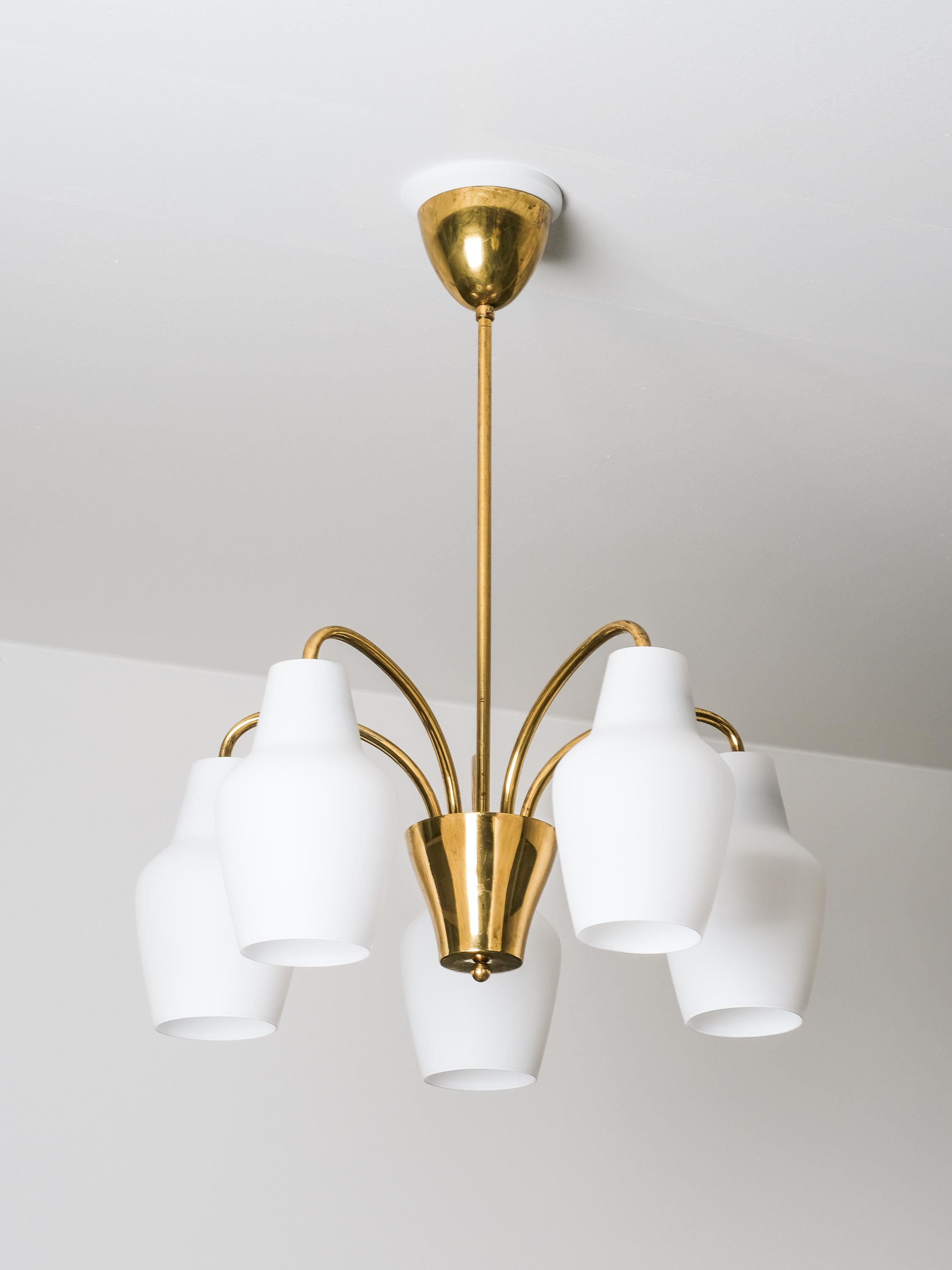 A sleek and delicate Finnish mid-century ceiling lamp that is made by Oy Stockmann-Orno A.B., one of the leading lighting manufacturers in Finland. The lamp features five lightbases with opaline glass shades. The lamp is stamped.

The overall