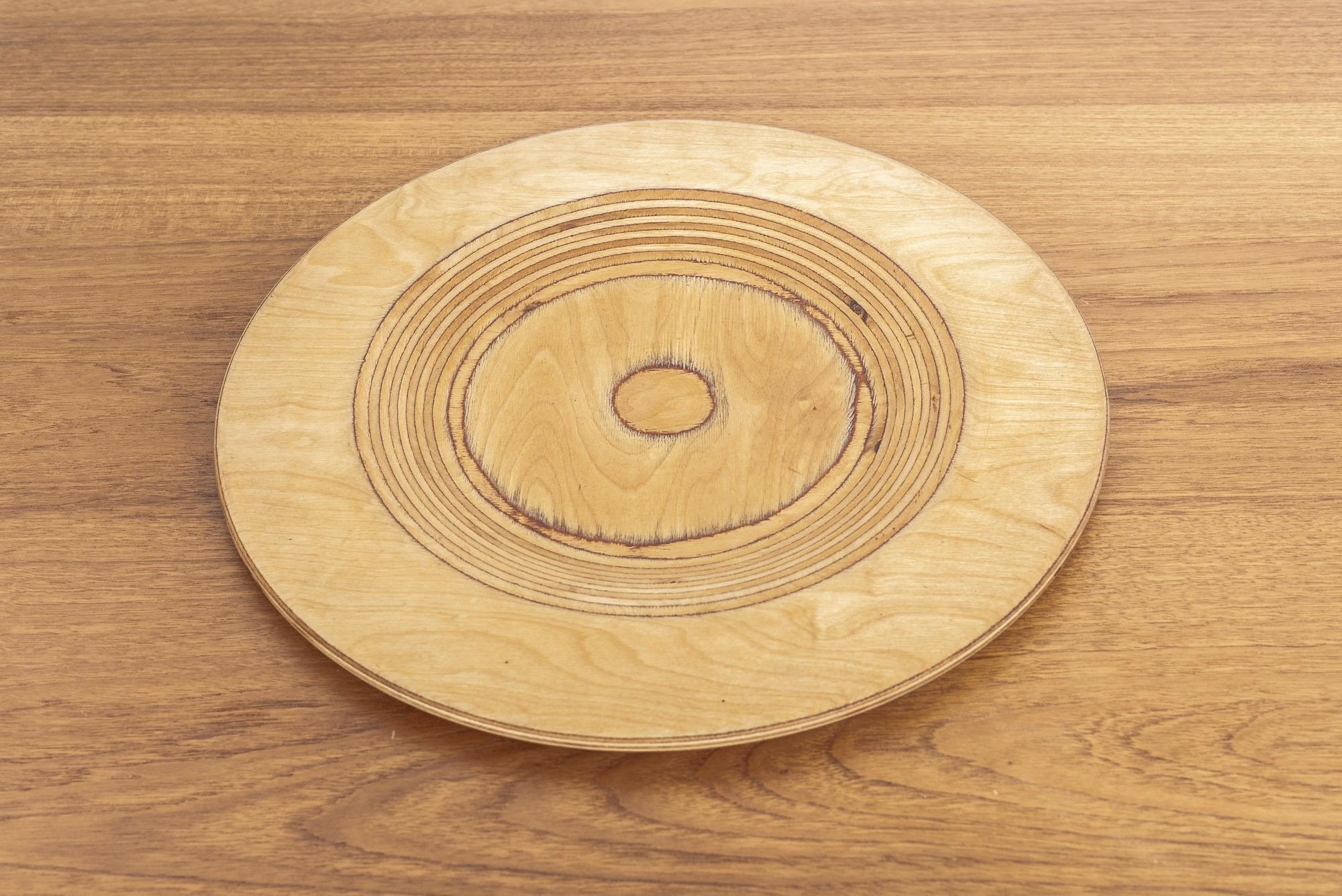 Listing is for one plate. Two smaller plates available separately.

This striking Mid-Century Modern wooden plate was designed by Saarinen and produced by Keuruu in Finland, circa 1960. The clean, Minimalist design crafted from turned birch