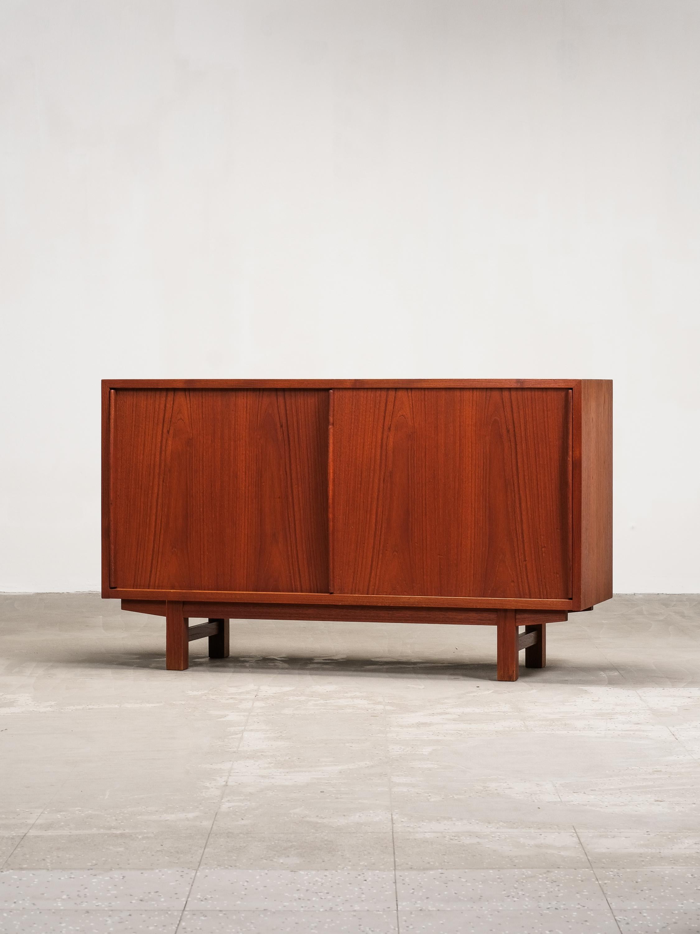 Questa eccezionale e rara credenza in teak, probabilmente progettata dal famoso designer finlandese Olli Borg negli anni '50, incarna il perfetto equilibrio tra design minimalista ed eleganza funzionale. Prodotto da Asko, questo pezzo vintage