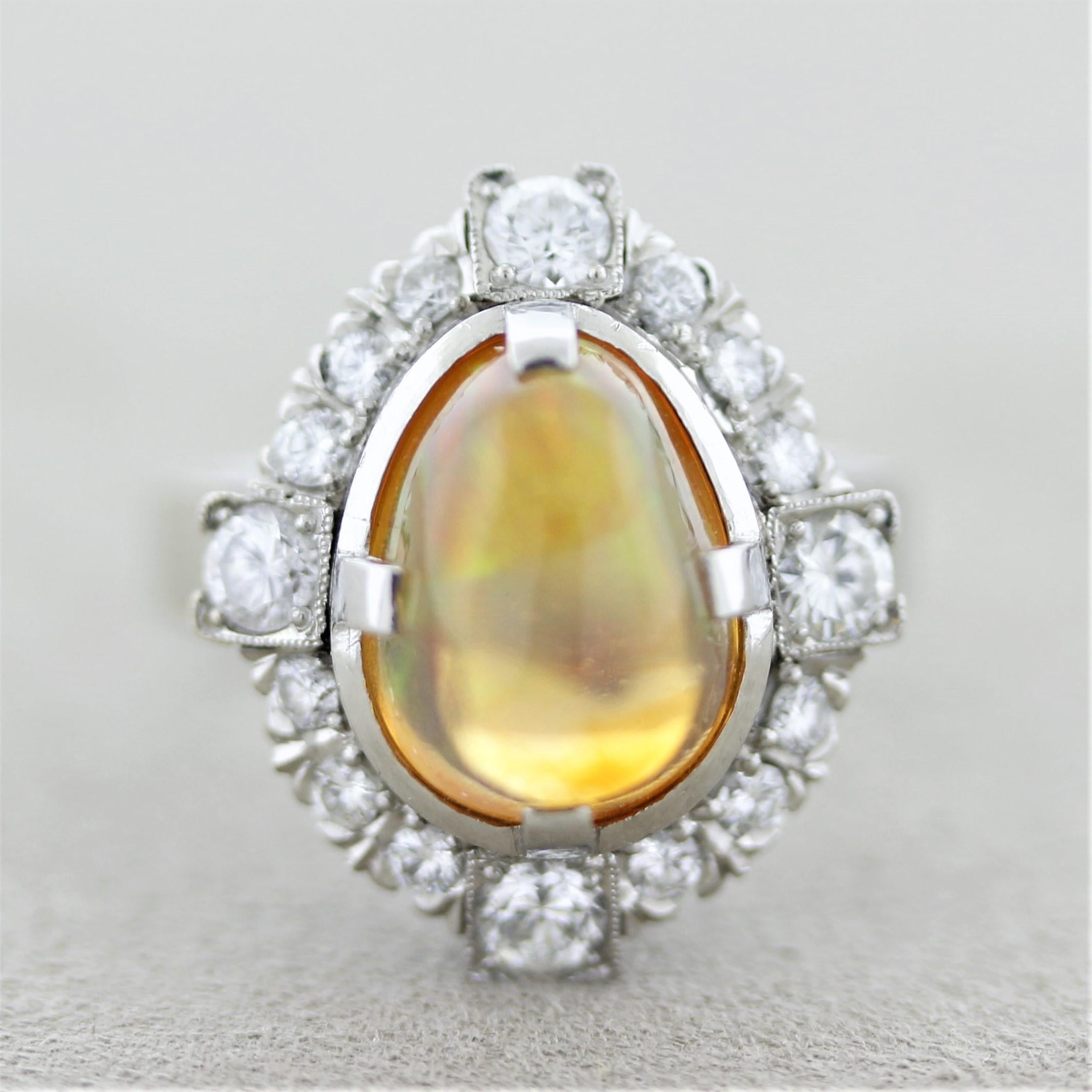 A lovely ring made in the 1960’s featuring a fine Mexican fire opal weighing approximately 3 carats. It has a rich jelly orange color as well as possessing excellent play-of-color as flashes of blue, green, red, orange, and yellow dance across the