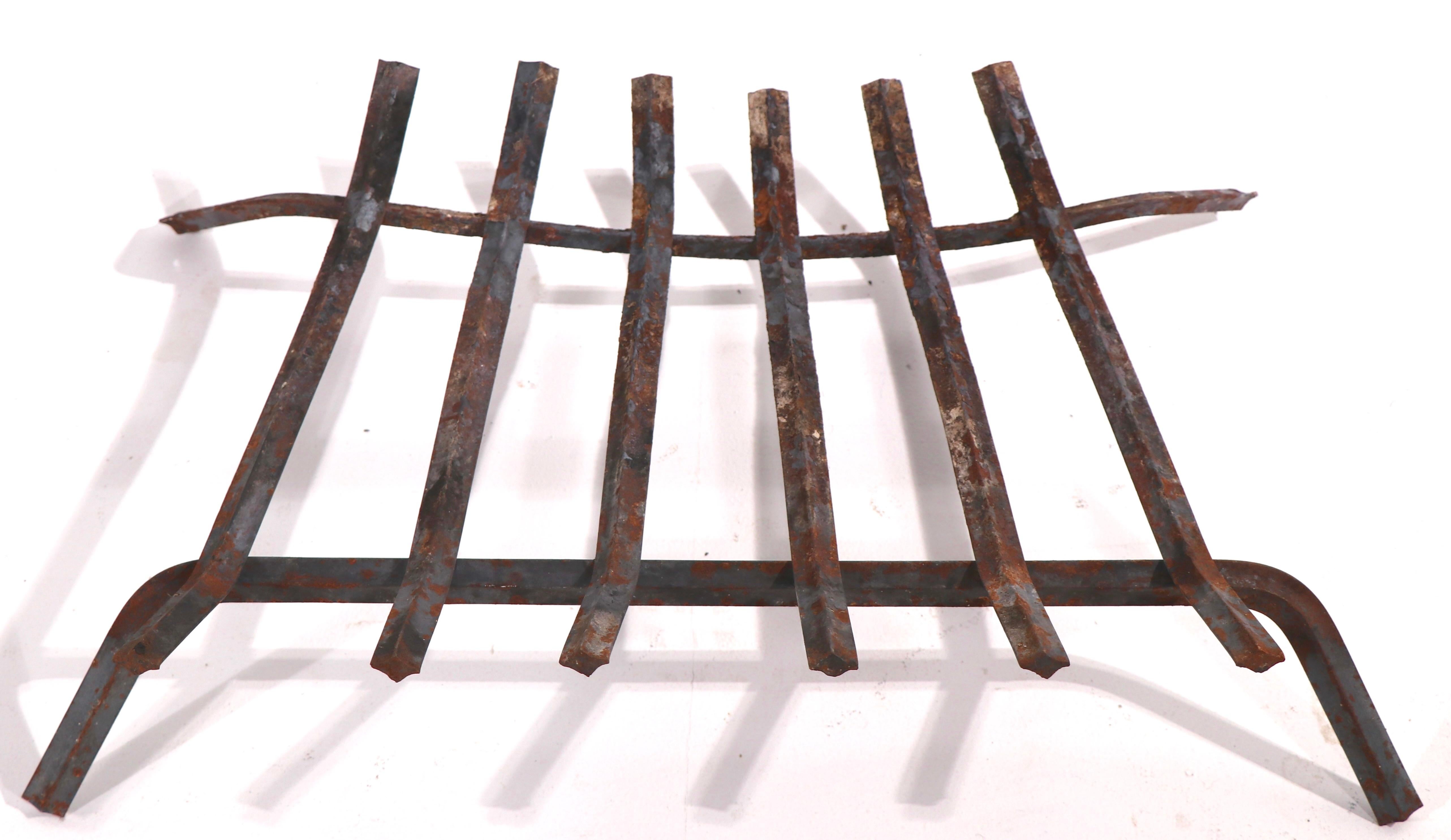Iron log holder, fireplace insert grate. Nice vintage example, shows expected wear to finish, normal and consistent with age and use. 
 W - 24
H at Front - 6
H at Back - 4
D - 16 inches.
