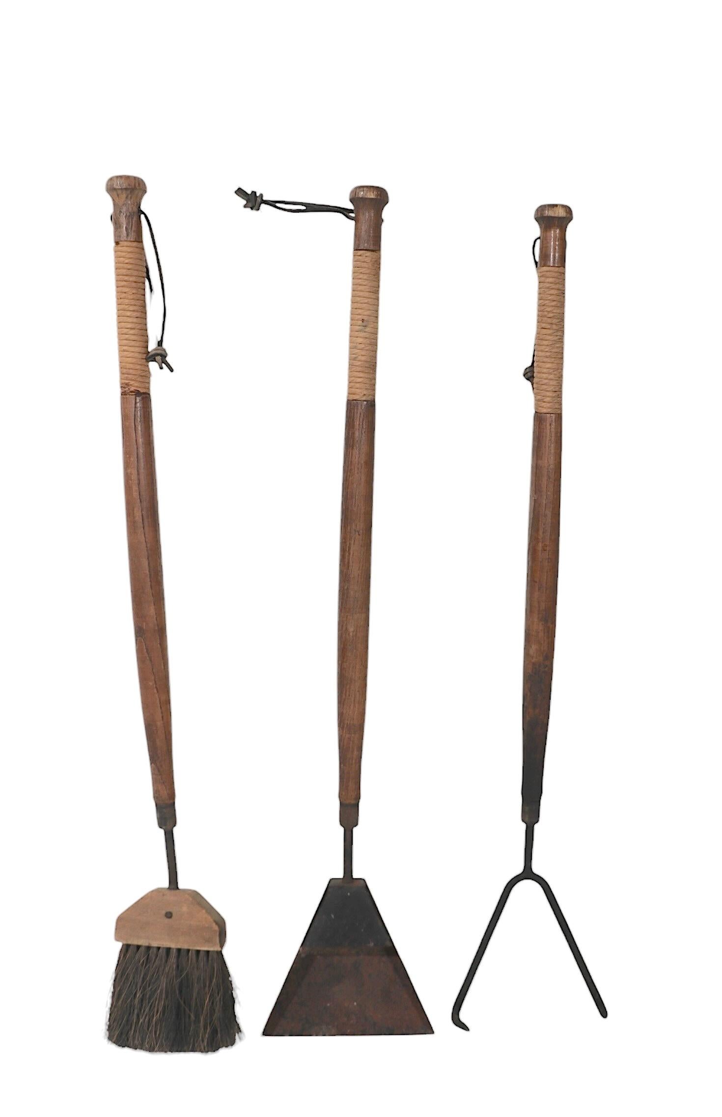 Rare Mid century fireplace tool set, circa 1950/60's attributed to Seymour. The seat feature three tools, fork, brush and shovel, and an unusual sculptural aluminum base. The set is in good, original, ready to use condition, showing some wear, and