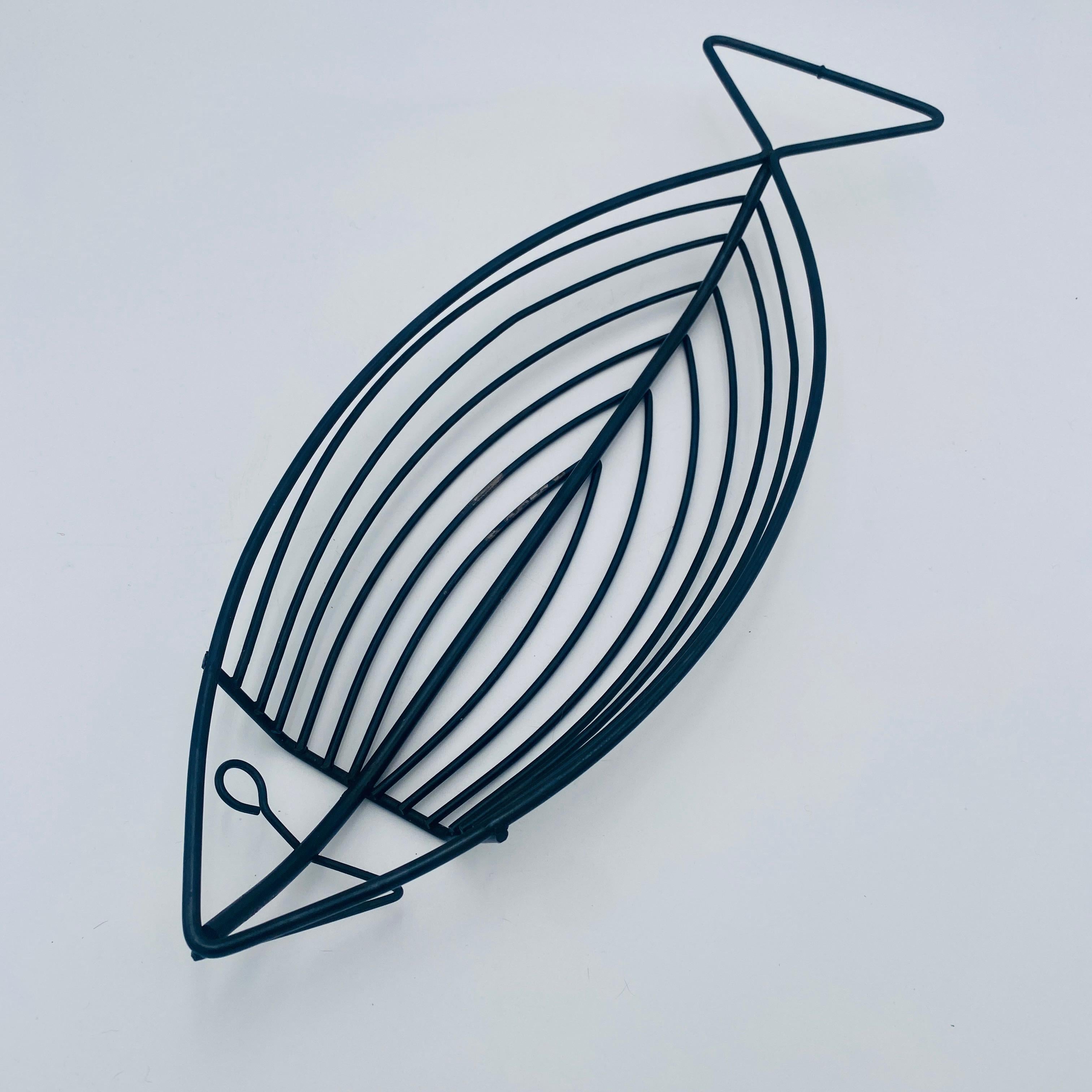 Sculptural basket shaped like a stylized fish, designed and made by Laurids Lønborg in Denmark during the 1960s. It is executed in blackened iron. This is an iconic mid-century design that is both decorative and functional. 