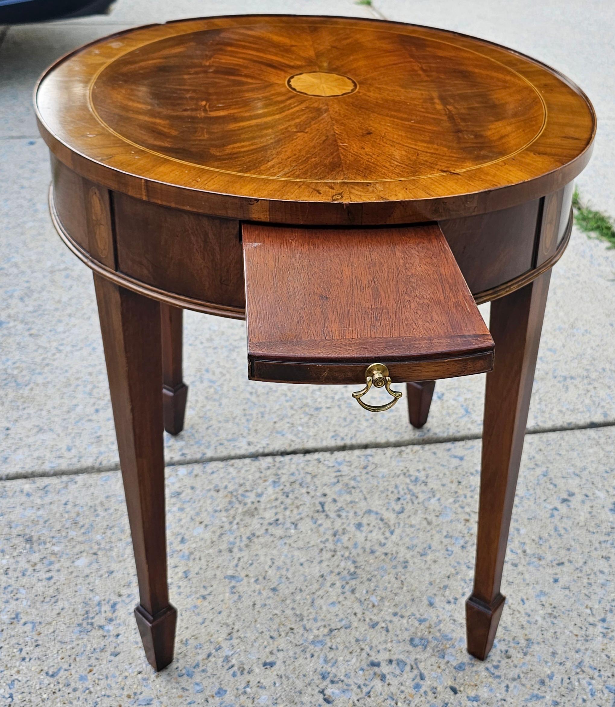 A Mid-Century Flame Mahogany Oval Gueridon Table With Pull-Out Tray with tapered legs.
Measures 23