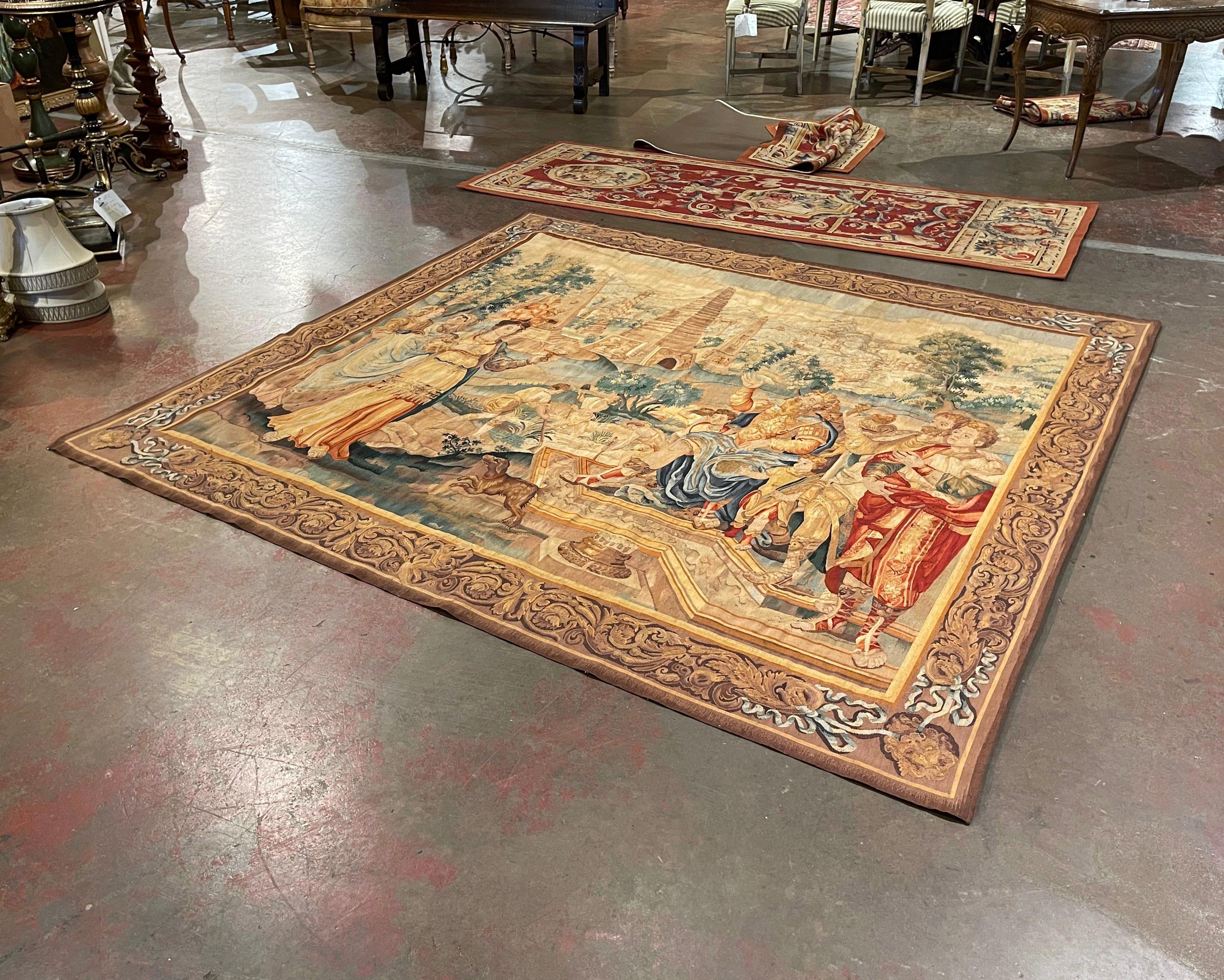 Decorate a wall or a staircase with this colorful large antique biblical tapestry. Handwoven in Belgium, circa 1950, the colorful wall piece depicts a climactic moment from the Biblical account of the Purim story, with Queen Esther, a Jew,