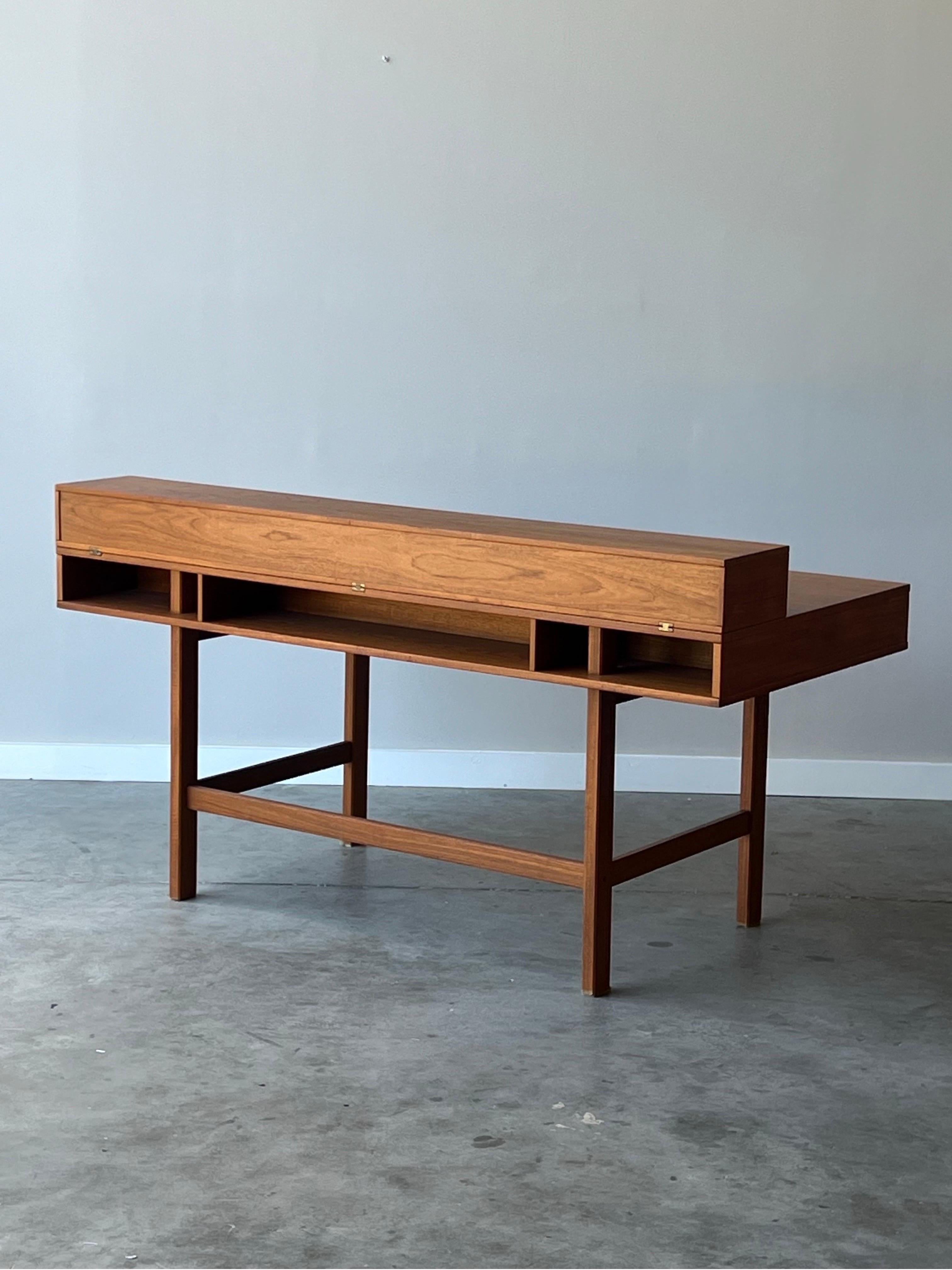 Mid-century Danish teak executive desk with flip-top mechanism. Designed by Peter Løvig Nielsen circa 1970s. This iconic desk has become well known within the world of mid-century design and for good reason.

The useable surface area atop the desk
