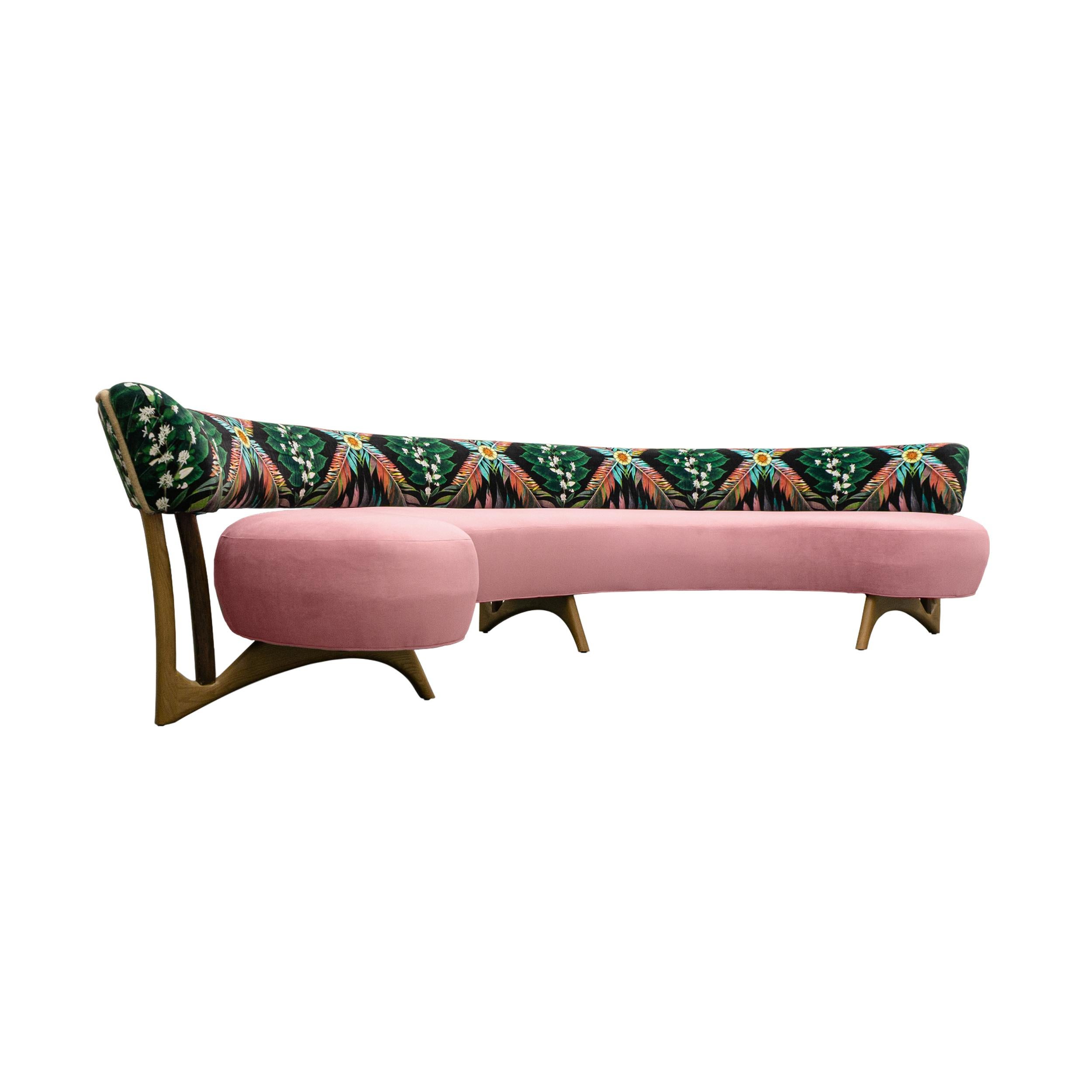 This midcentury floating curved sofa features a soft decorative printed velvet from Christian Lacroix on the back, a rich pile velvet weave in blossom pink on the seat, burlap welting on the back edges and morado accented stained white oak curved